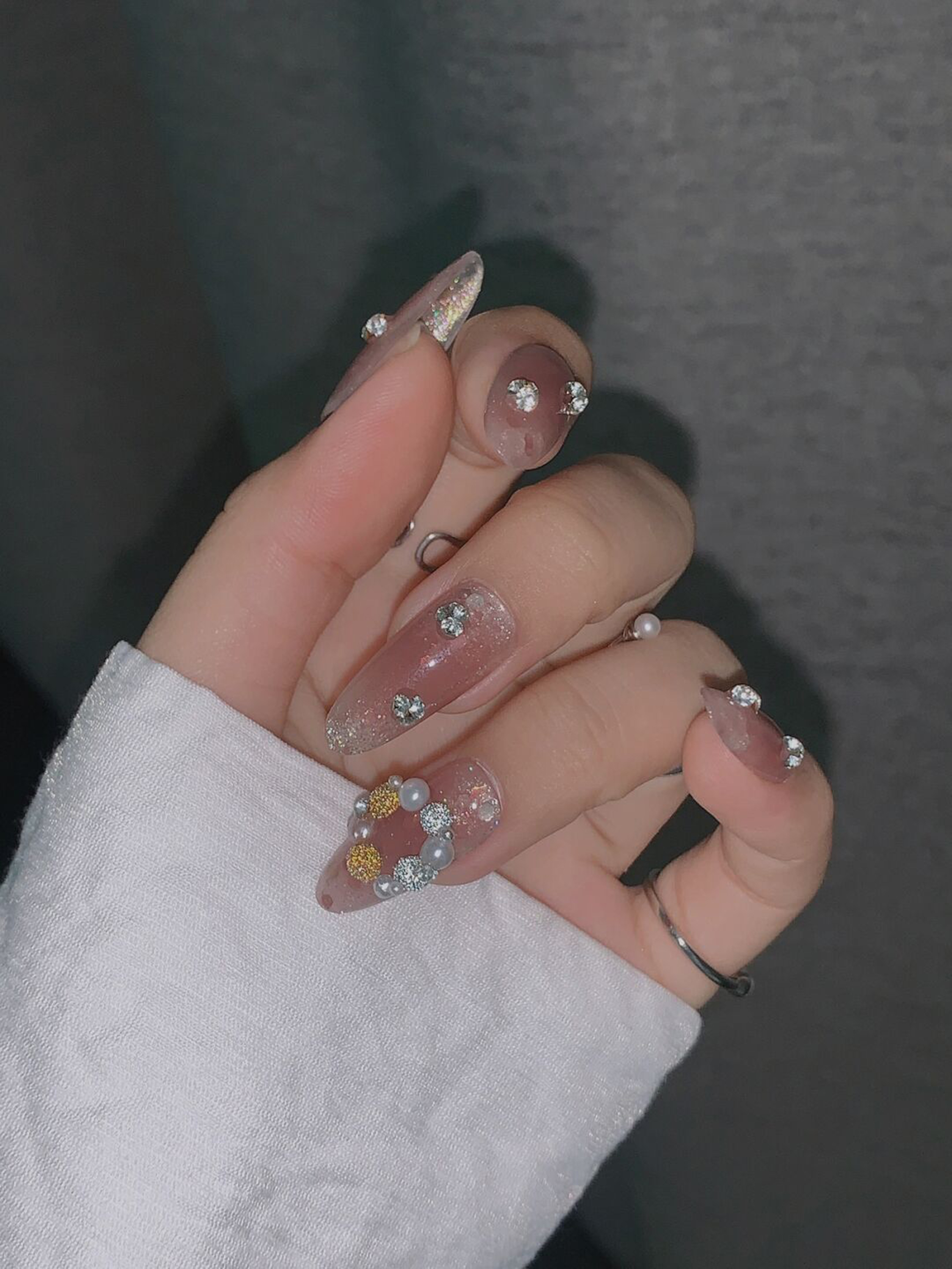 Silver and Nude Floral Almond Nails shown as a nail art design with silver, nude, 3d, elegant, flower, almond and medium details.