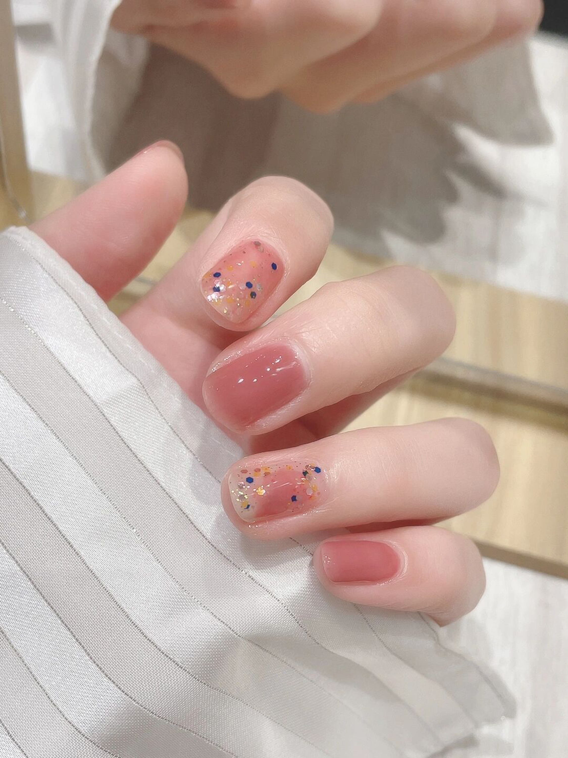 Nude and Pink Glitter Short Round Nails shown as a nail art design with nude, pink, glitter, simple, round and short details.