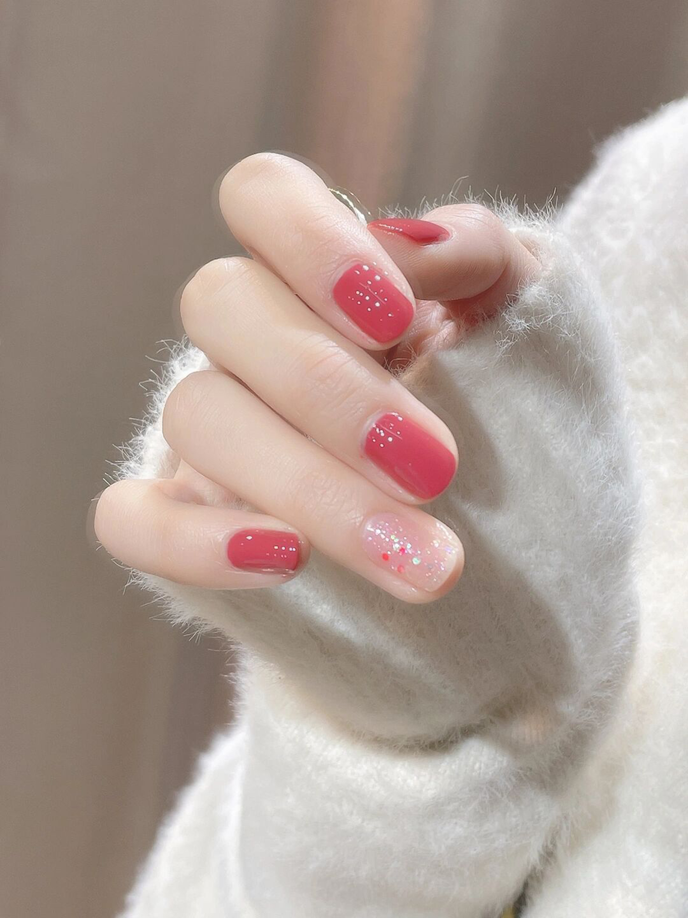 Red and Nude Glitter Short Nails shown as a nail art design with red, nude, glitter, simple and short details.