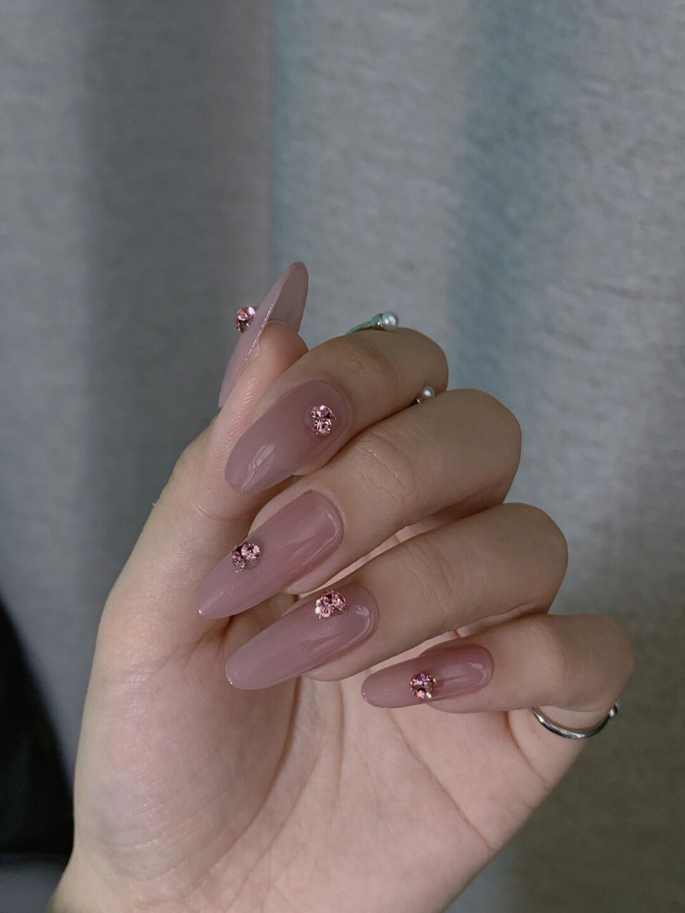 Nude and Pink Elegant Long Almond Nails shown as a nail art design with nude, pink, elegant, almond and long details.
