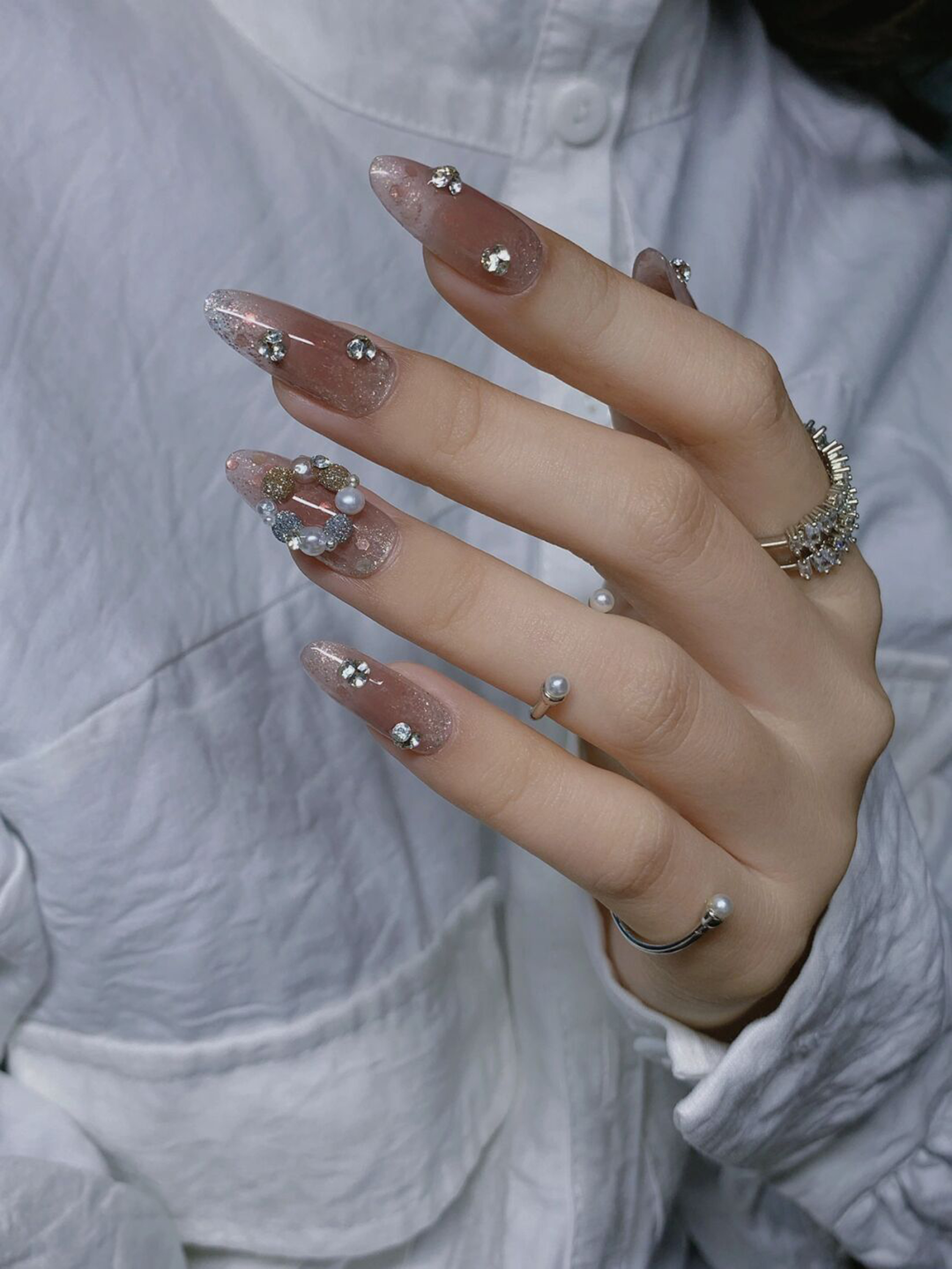 Nude and Silver Glitter Long Nails shown as a nail art design with nude, silver, glitter, 3d, elegant and long details.