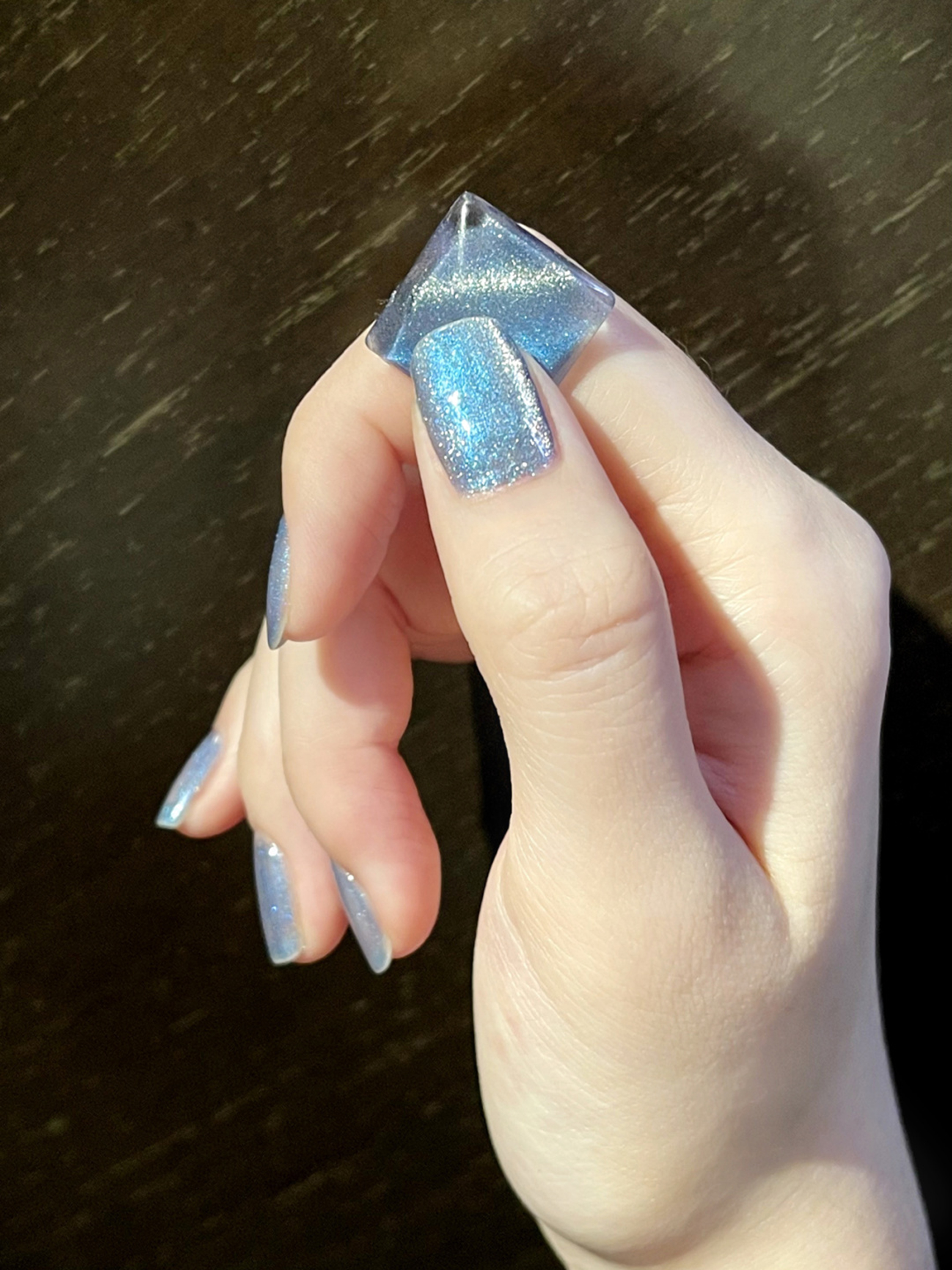 Blue and silver glitter nails with a glossy square shape.