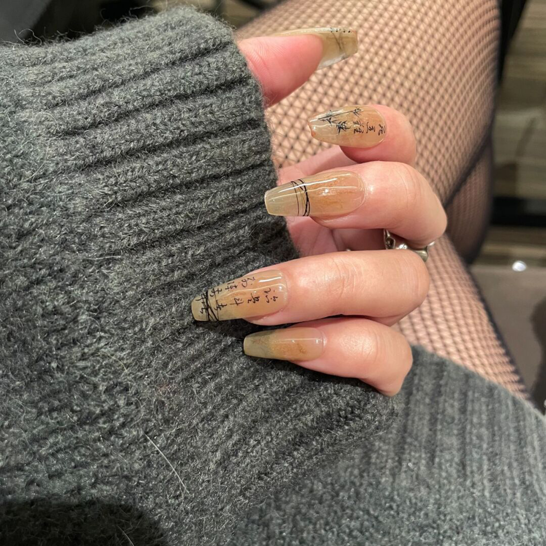 Black and Beige Abstract Long Coffin Nails shown as a nail art design with black, beige, abstract, coffin and long details.