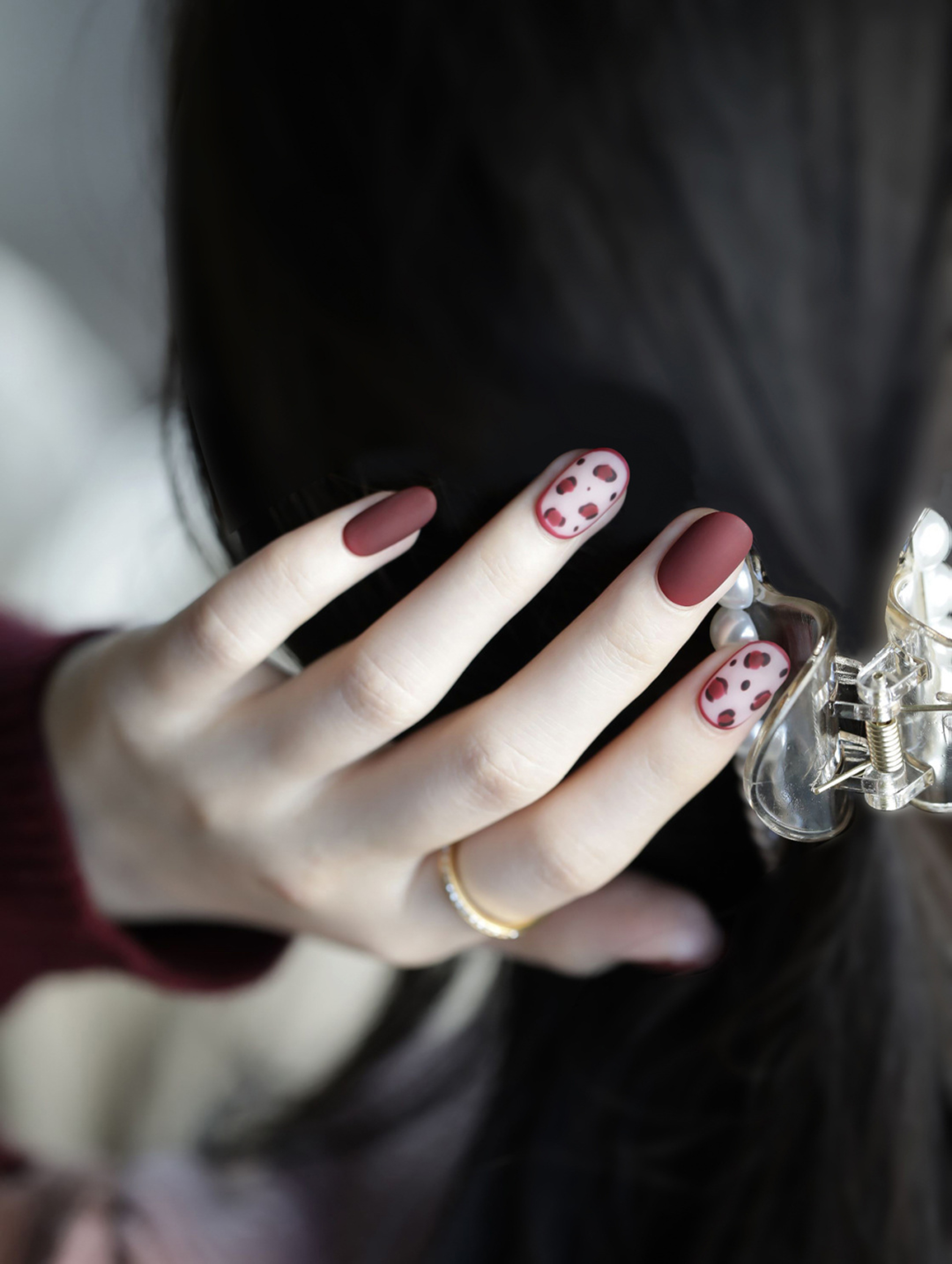 Burgundy Polka Dot Oval Nails shown as a nail art design with burgundy, elegant, polka dot, oval and medium details.