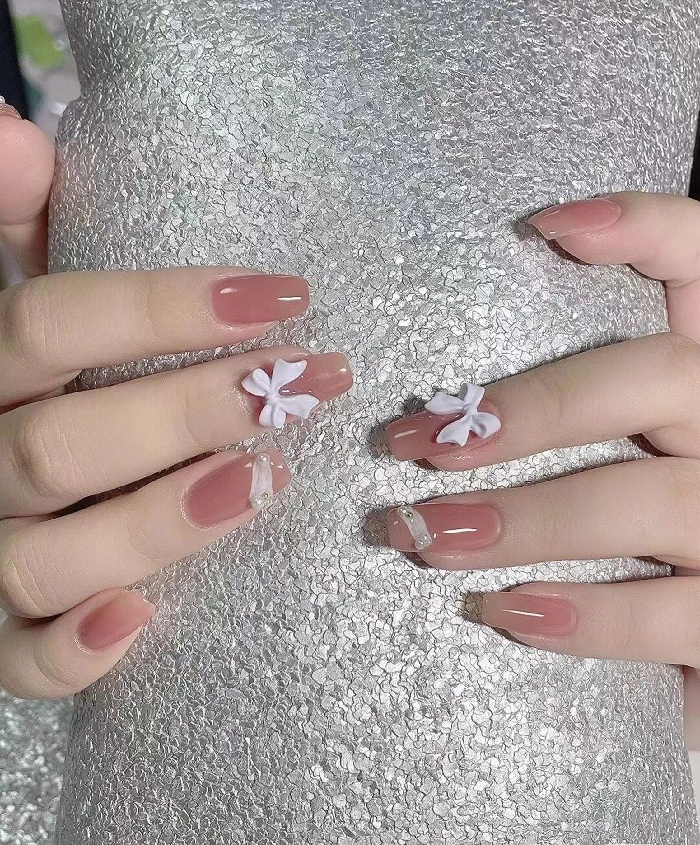 Nude and White 3D Nails shown as a nail art design with nude, white, 3d, elegant and medium details.