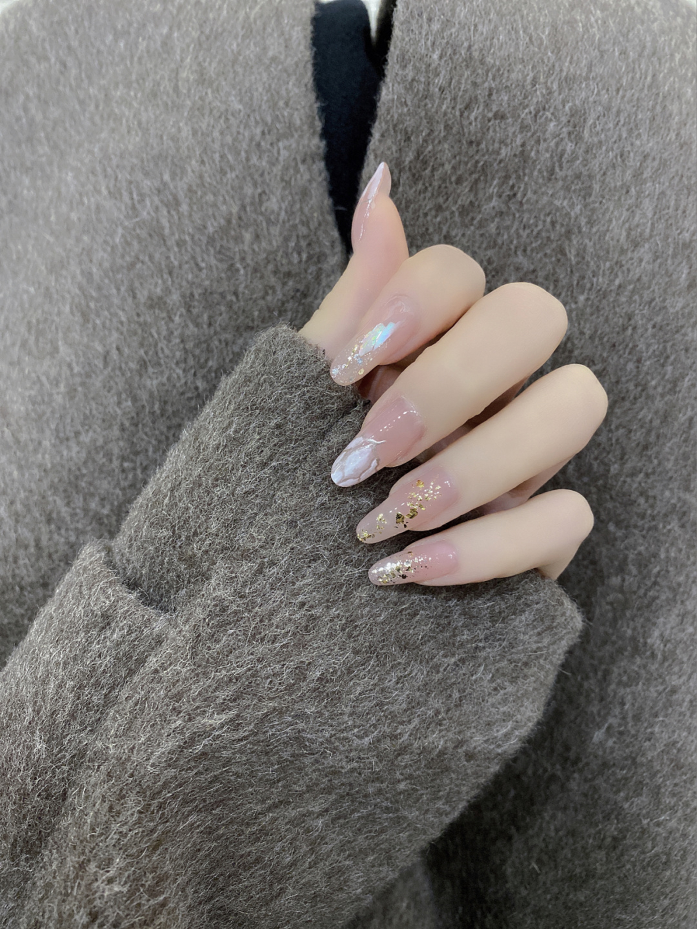 Nude, Gold and White Floral Long Almond Nails shown as a nail art design with nude, gold, white, elegant, marble, glitter, flower, almond and long details.