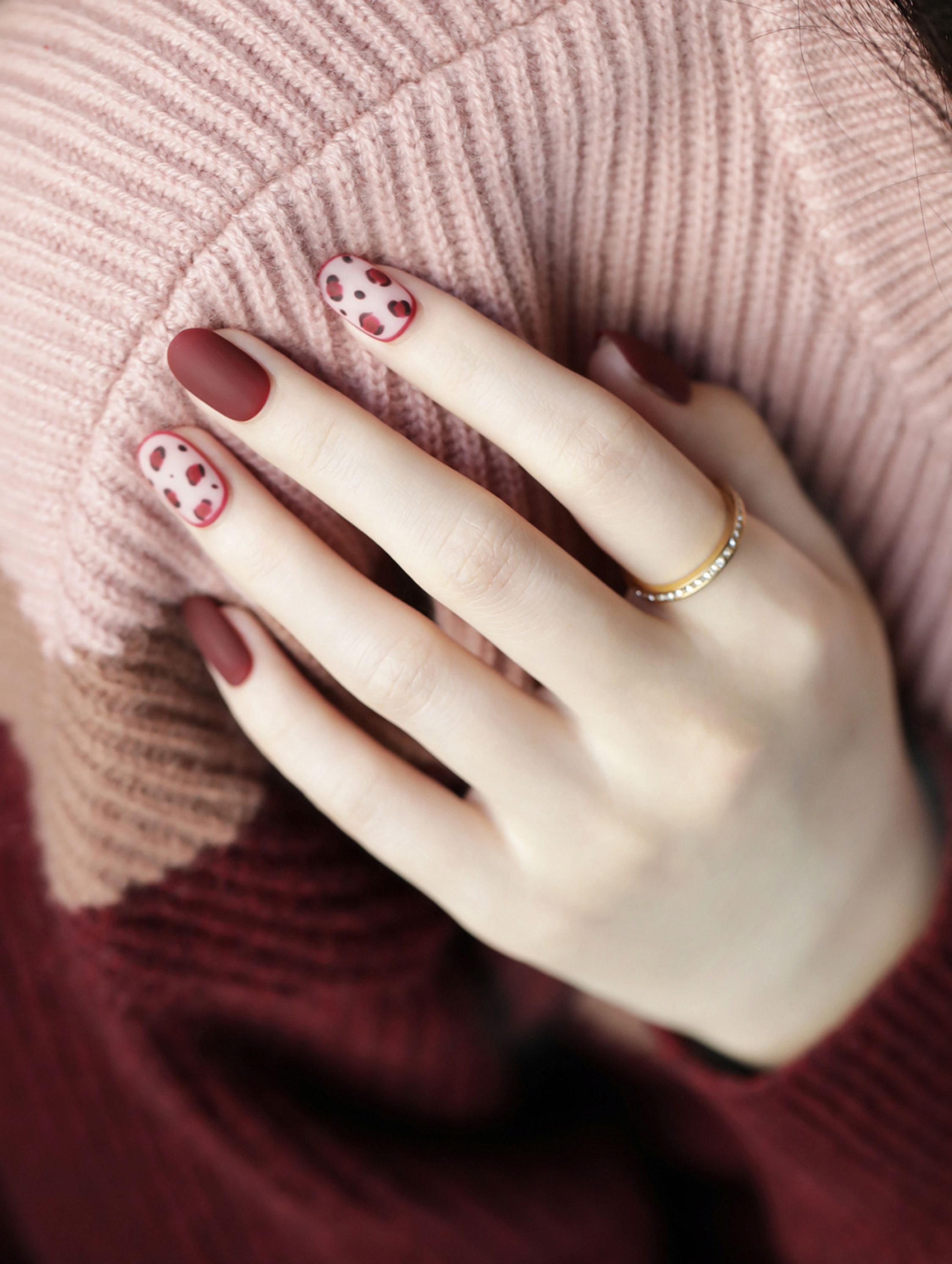 Burgundy and Pink Polka Dot Oval Nails shown as a nail art design with burgundy, pink, minimal, polka dot, oval and medium details.
