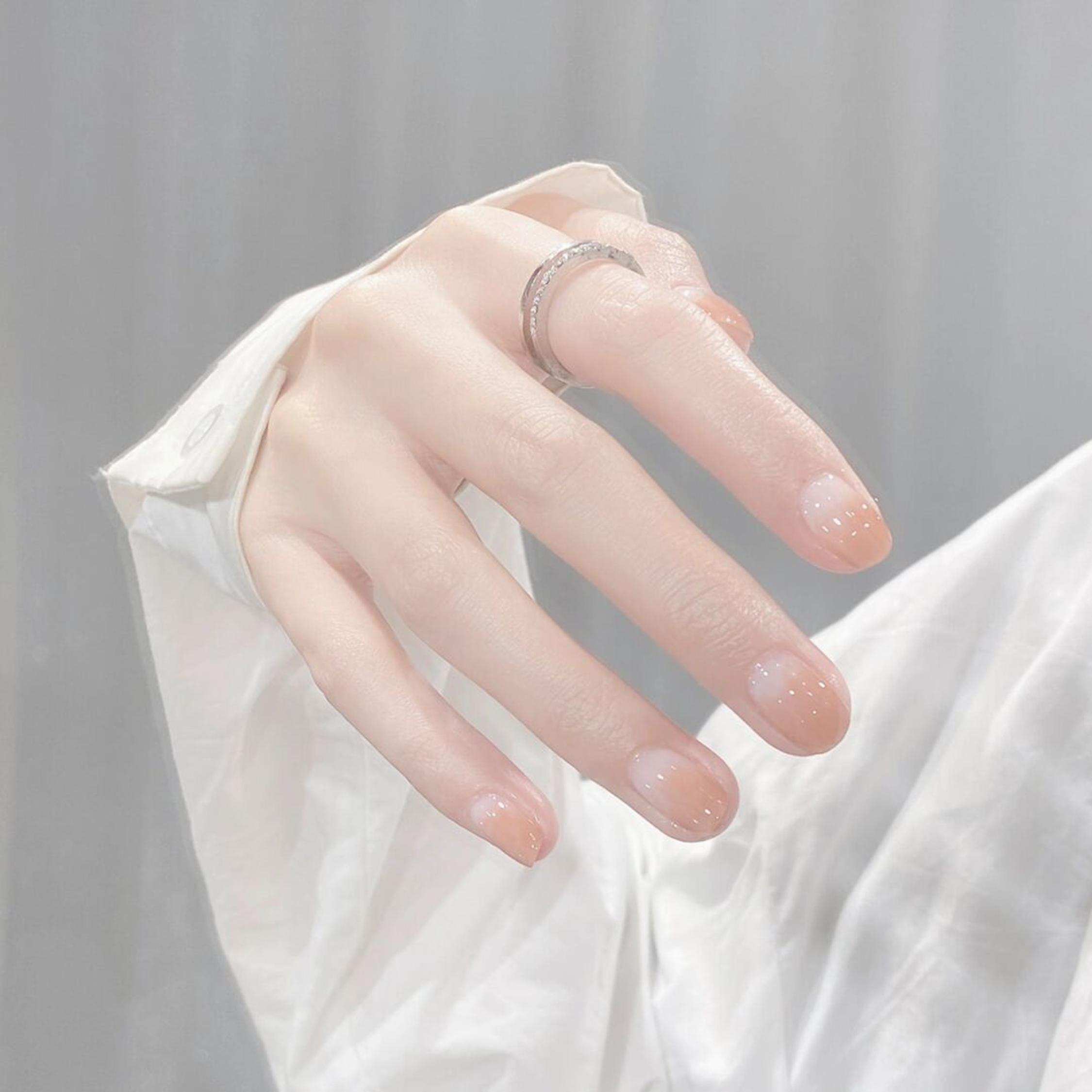 medium oval nude pink white nail design with simple and elegant and gel details and polka dot accents