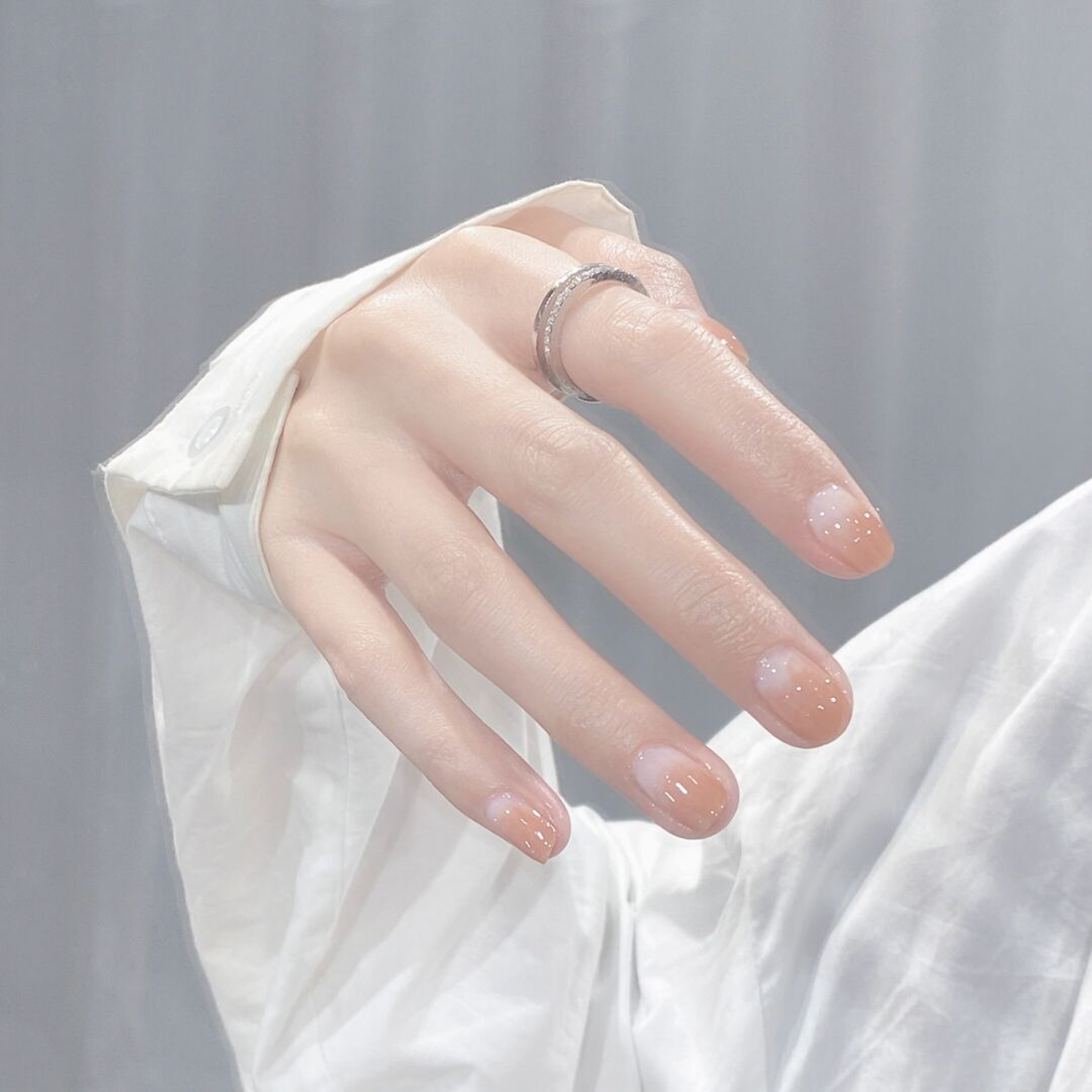 medium oval nude pink white nail design with simple and elegant and gel details and polka dot accents