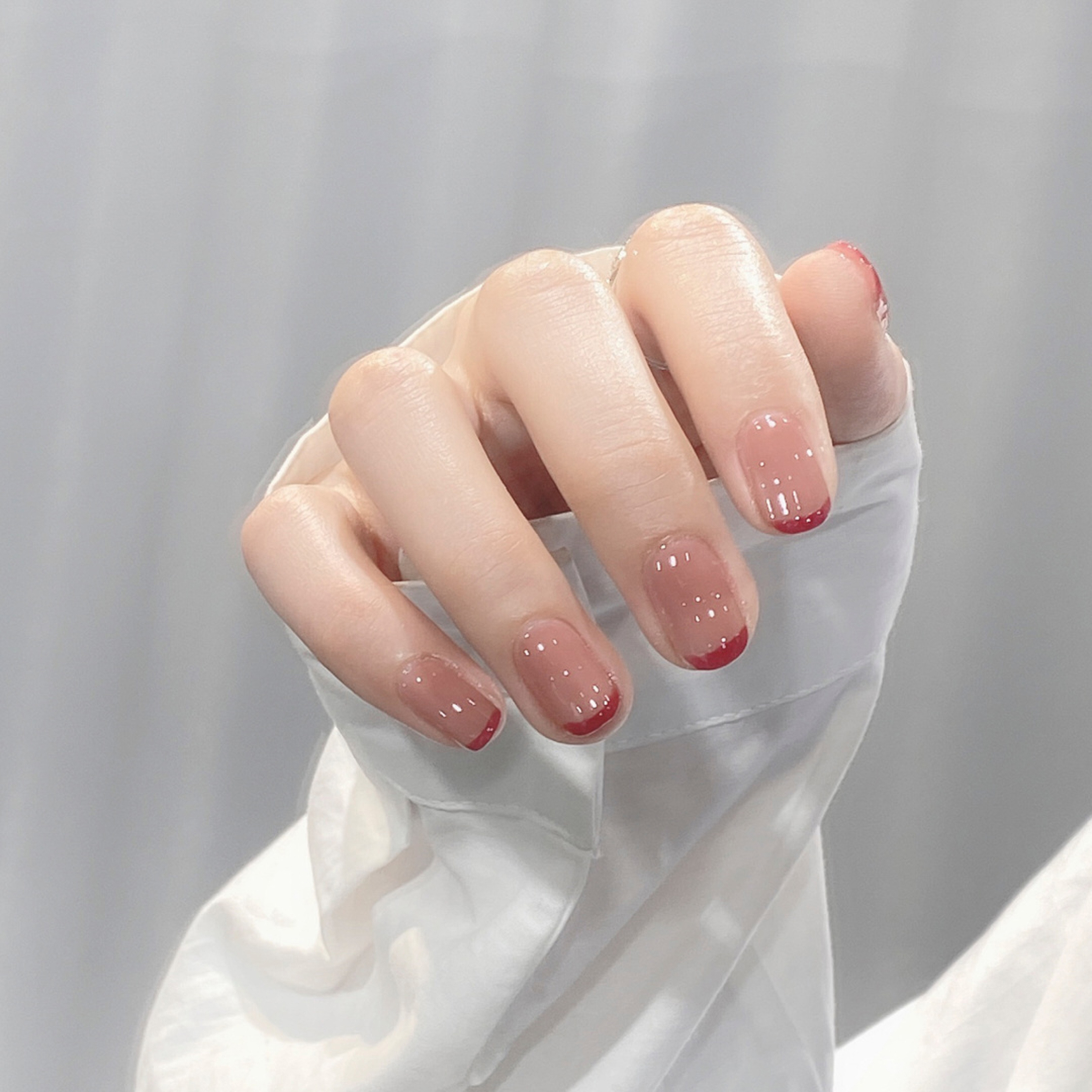 Nude and Red French Tip Short Nails shown as a nail art design with nude, red, french and short details.