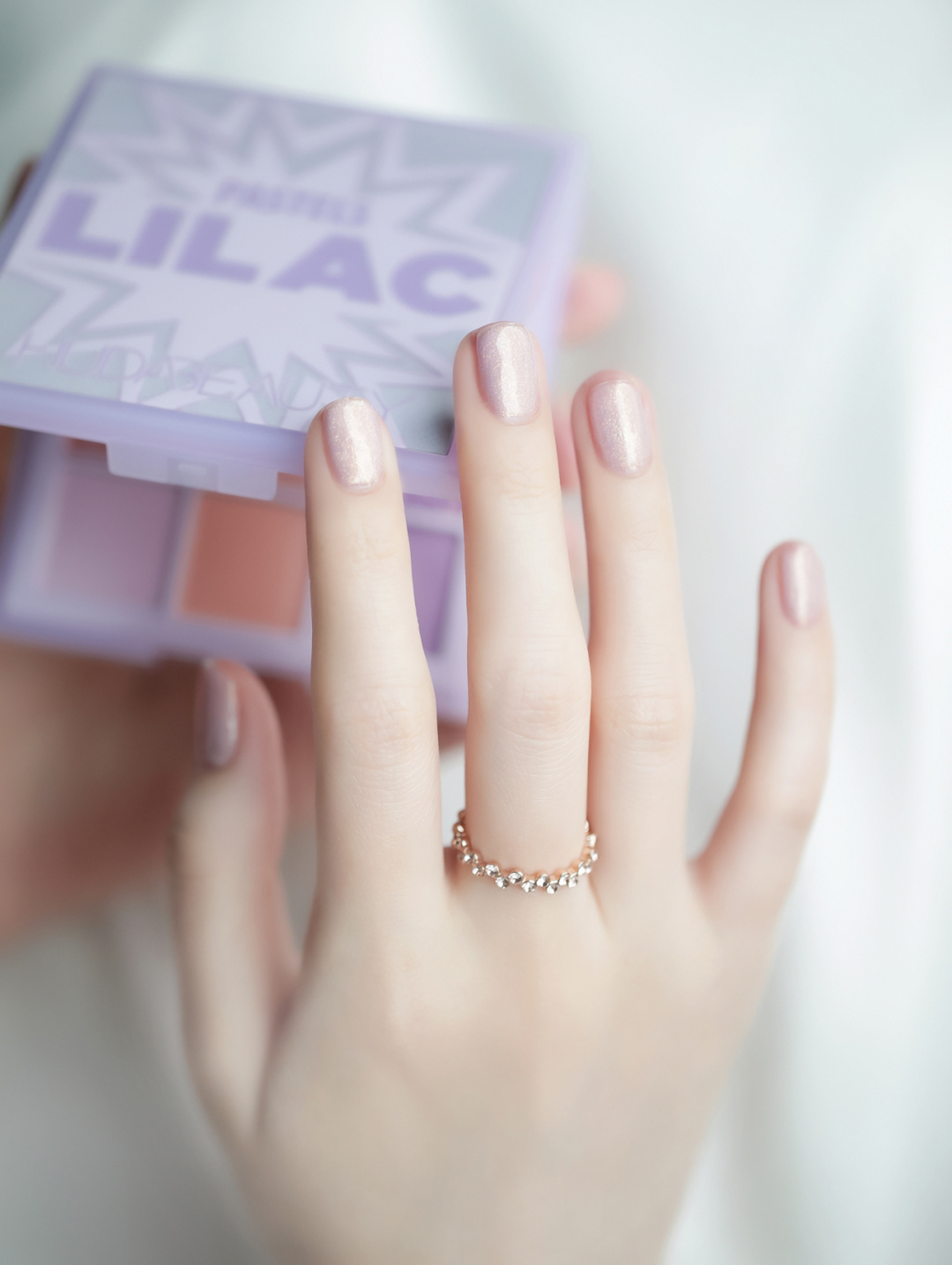 Nude and pink oval nail art with a soft shimmer finish.