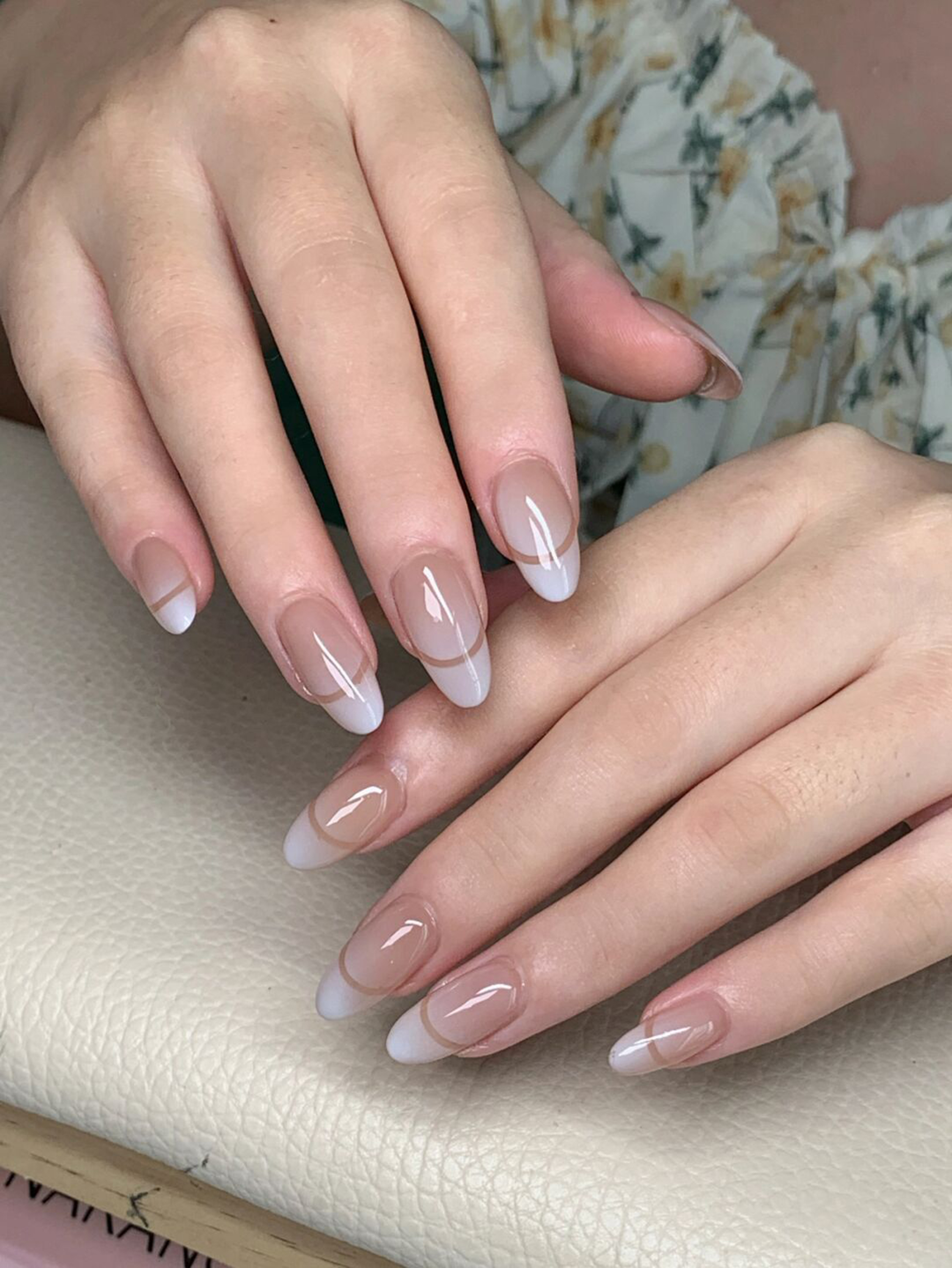 Nude and White French Tip Almond Nails shown as a nail art design with nude, white, french, elegant, almond and medium details.
