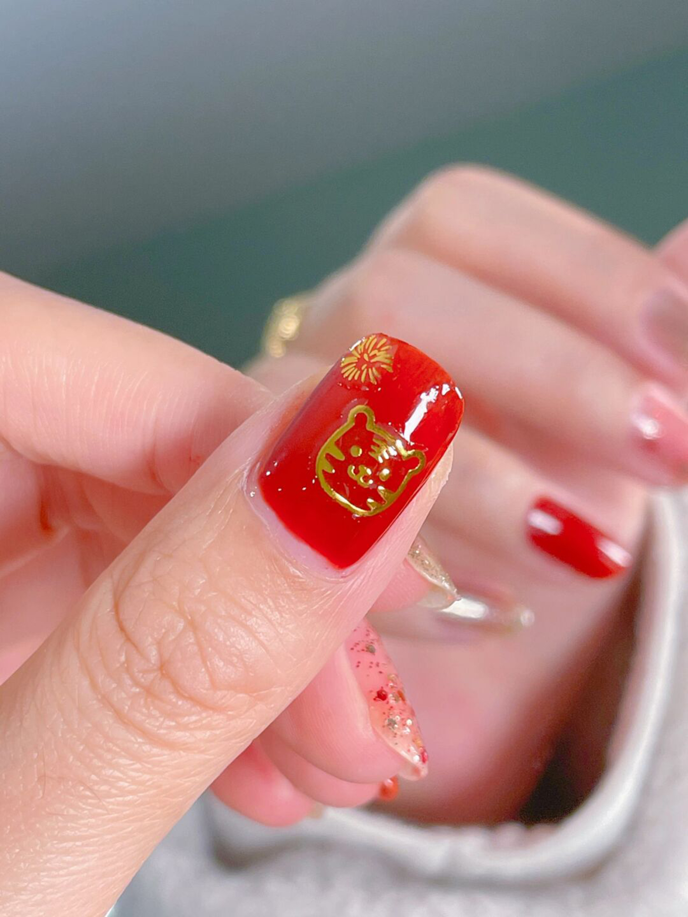 Red and Gold Simple Short Round Nails shown as a nail art design with red, gold, simple, round and short details.