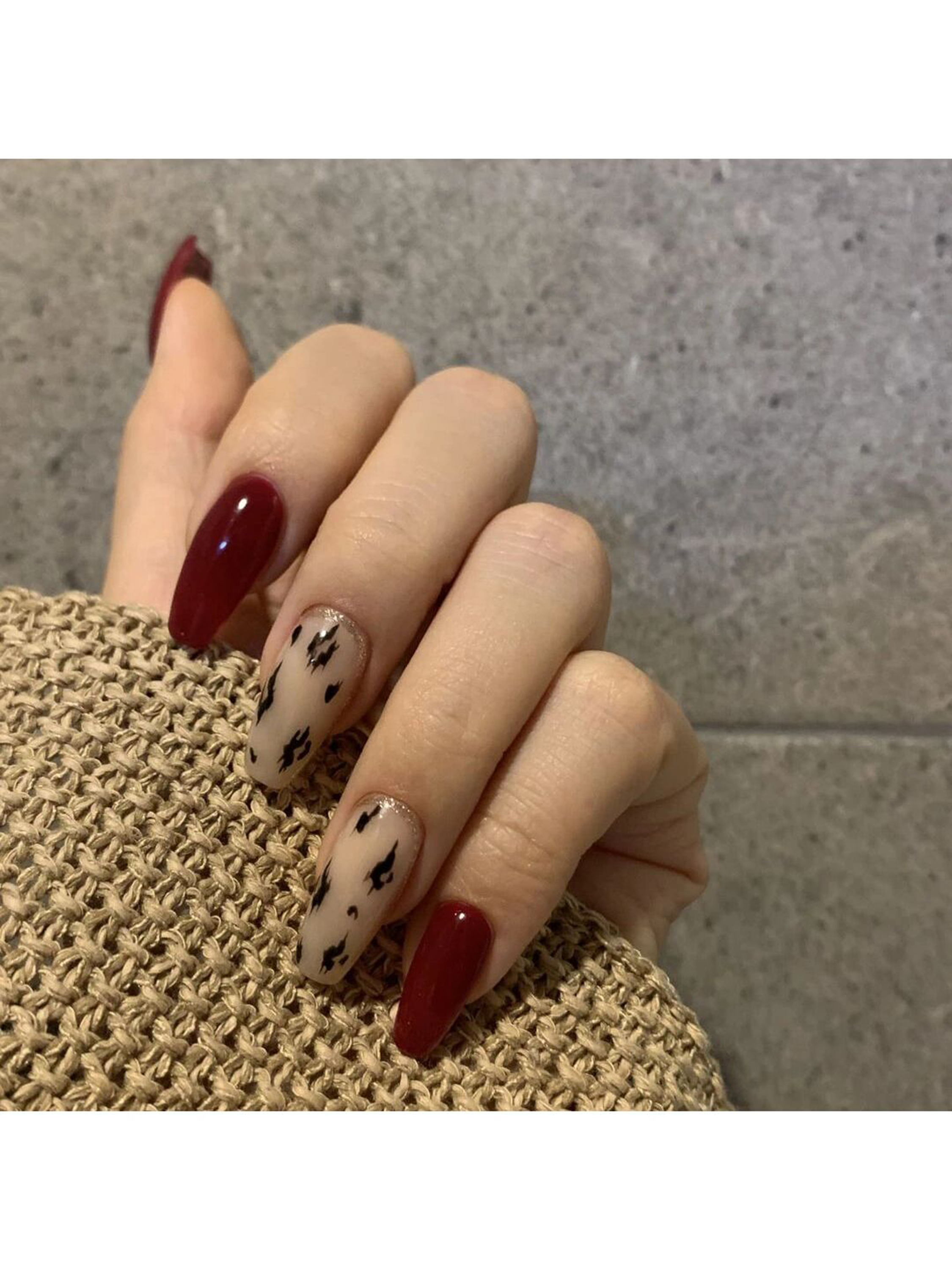 Burgundy and Brown Elegant Almond Nails shown as a nail art design with burgundy, brown, elegant, leopard, almond and medium details.