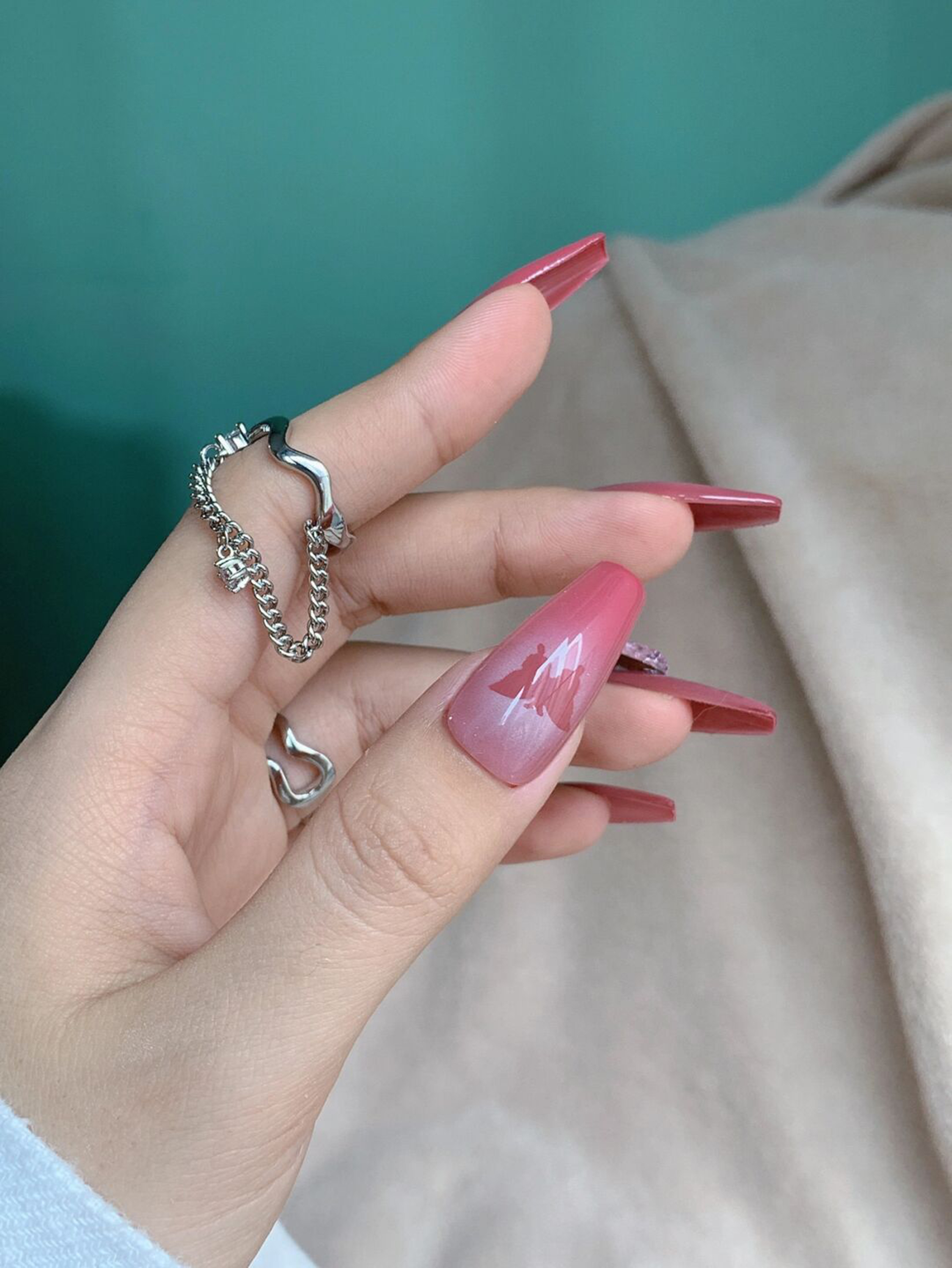 Pink long stiletto nail art with a glossy elegant finish.
