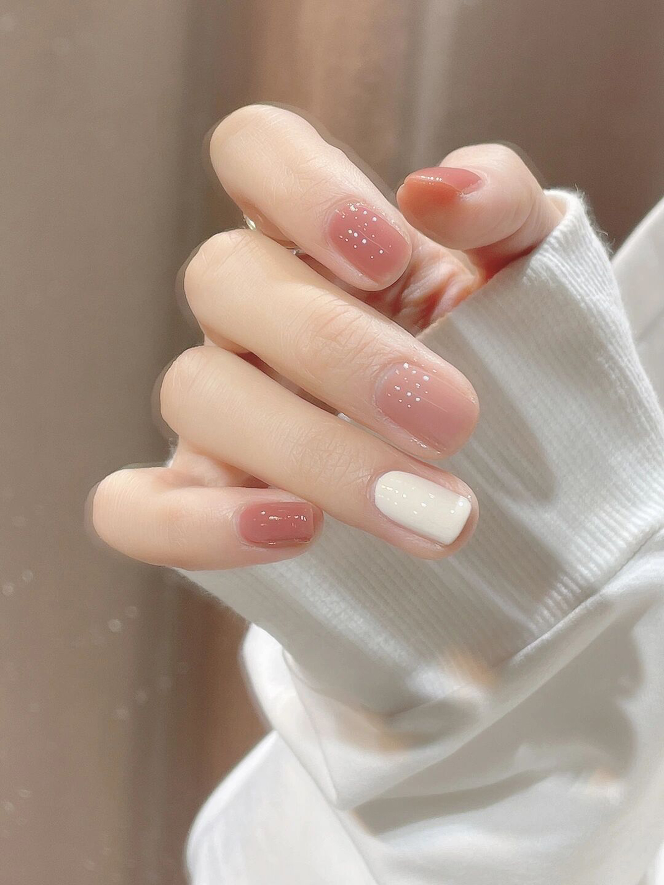 Nude and White Polka Dot Short Round Nails shown as a nail art design with nude, white, simple, cute, polka dot, round and short details.