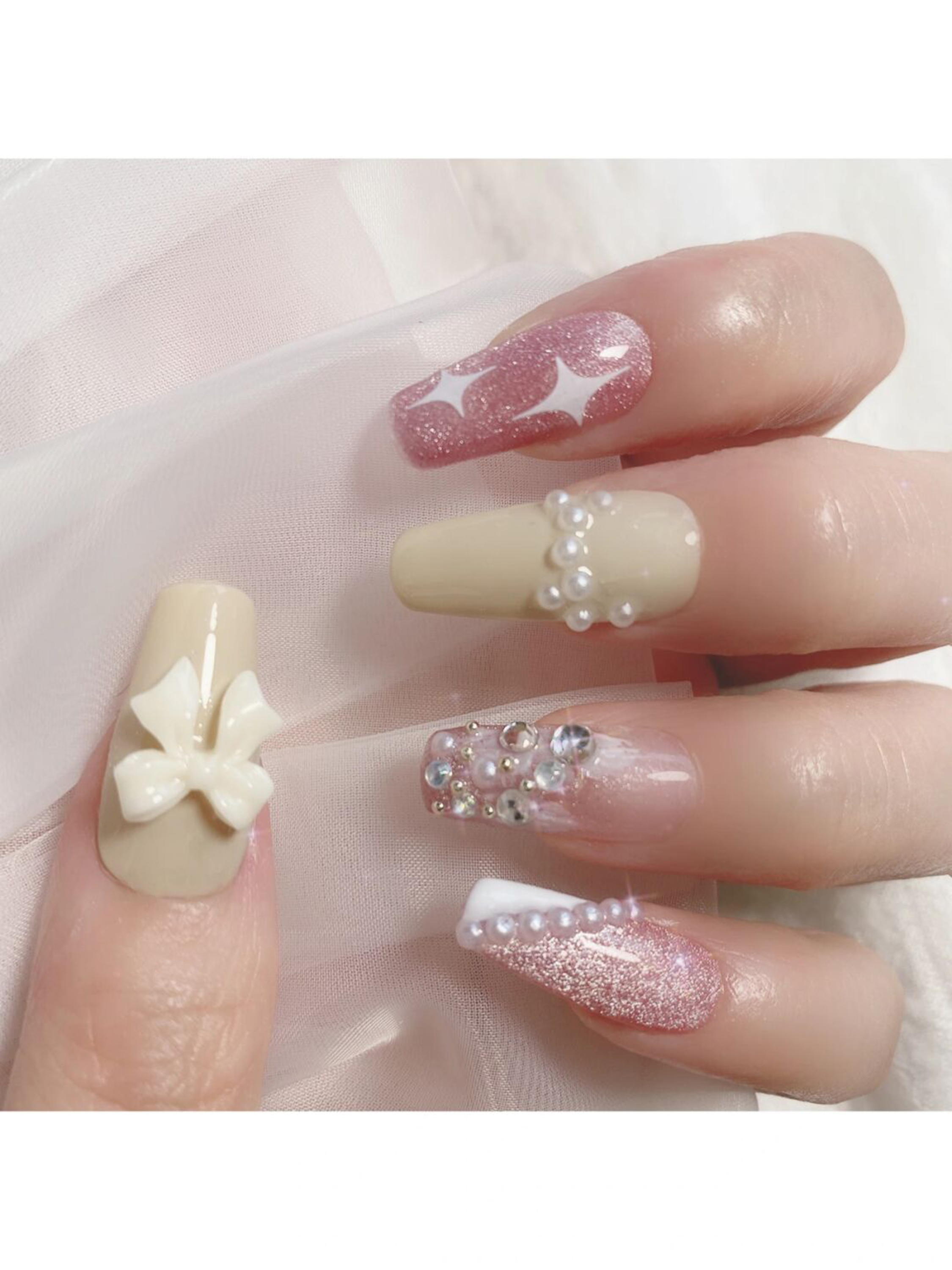 Nude and White Bow Long Coffin Nails shown as a nail art design with nude, white, elegant, coquette, glitter, bow, coffin and long details.