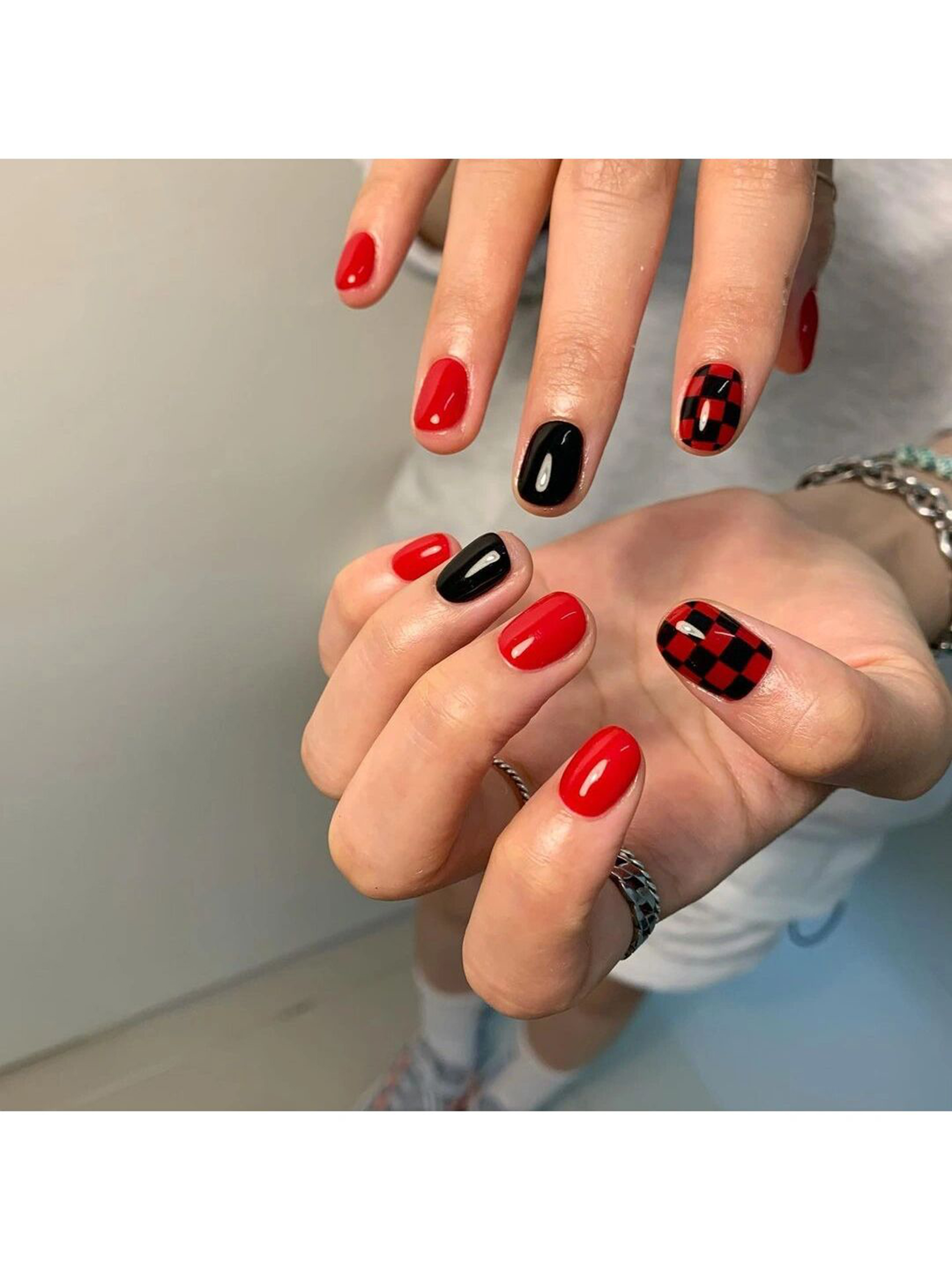 Red and Black Checkerboard Short Round Nails shown as a nail art design with red, black, aesthetic, checkerboard, round and short details.
