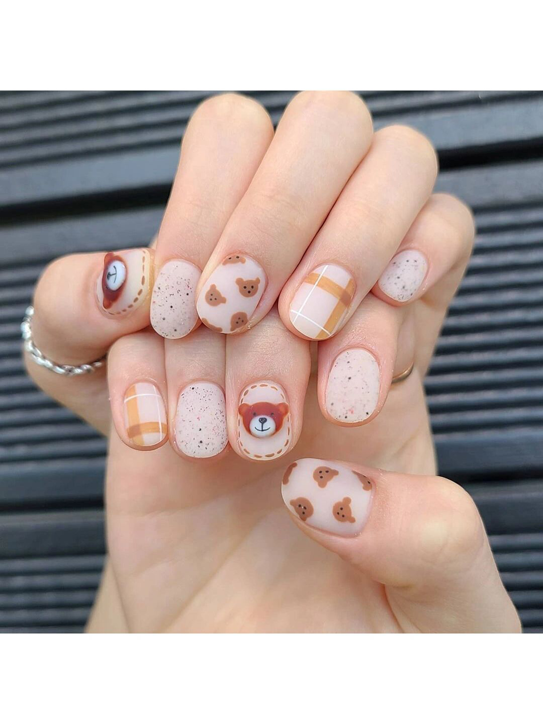 Nude and Brown Heart Short Round Nails shown as a nail art design with nude, brown, cute, animal print, heart, round and short details.