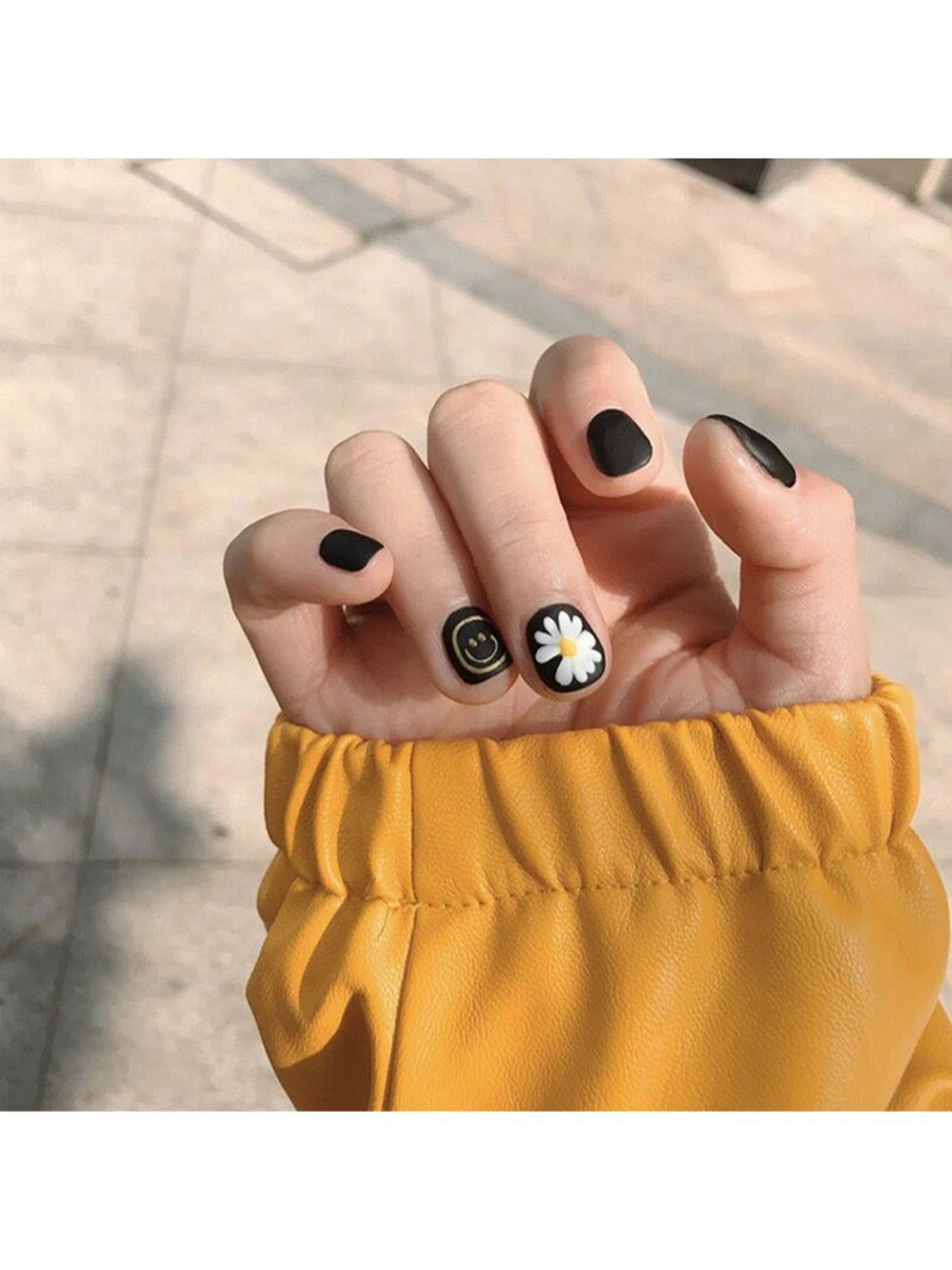 White and Black Minimal Short Round Nails shown as a nail art design with white, black, minimal, cute, daisy, round and short details.