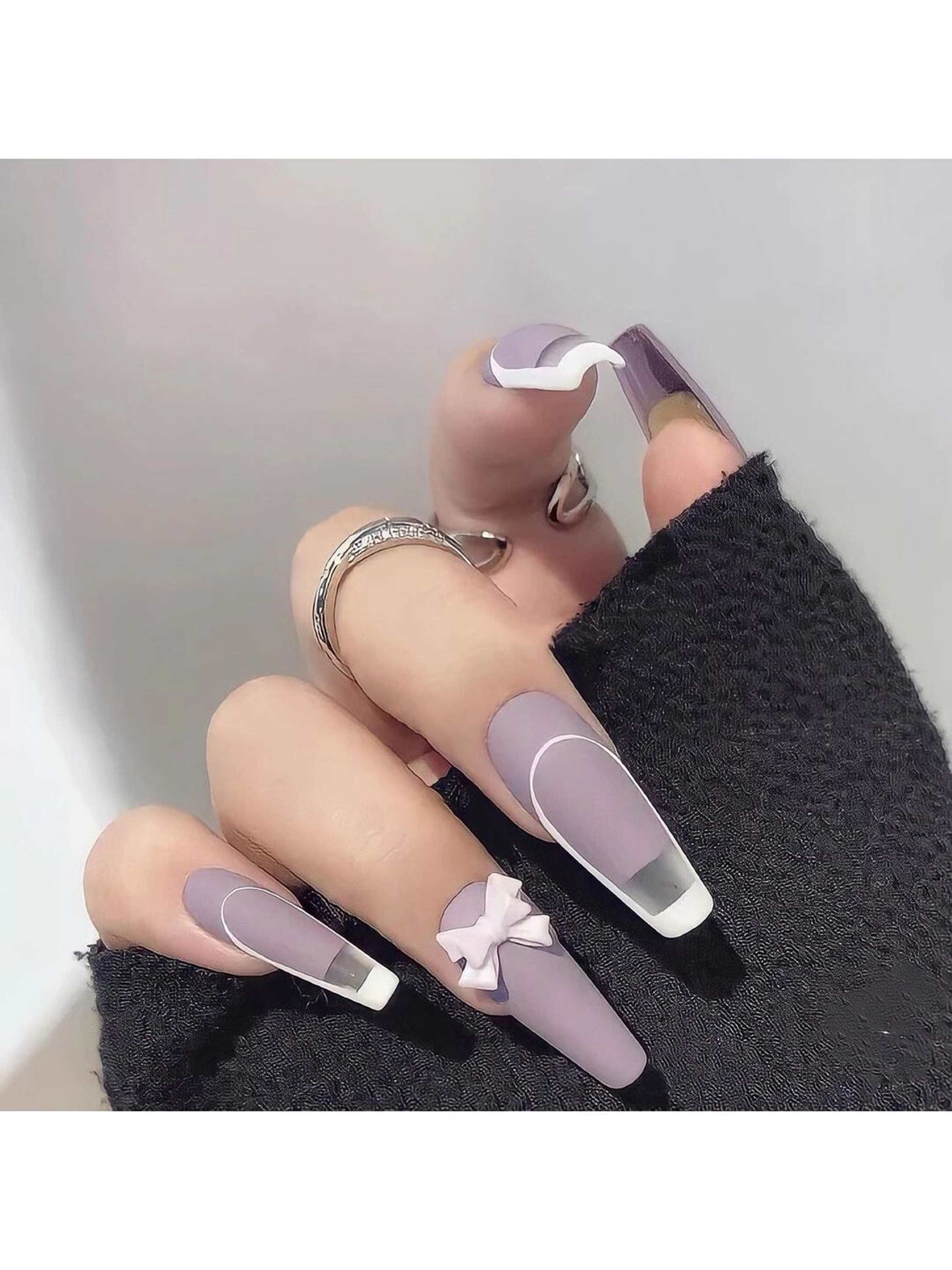 Purple and White Bow Long Coffin Nails shown as a nail art design with purple, white, coquette, aesthetic, bow, coffin and long details.
