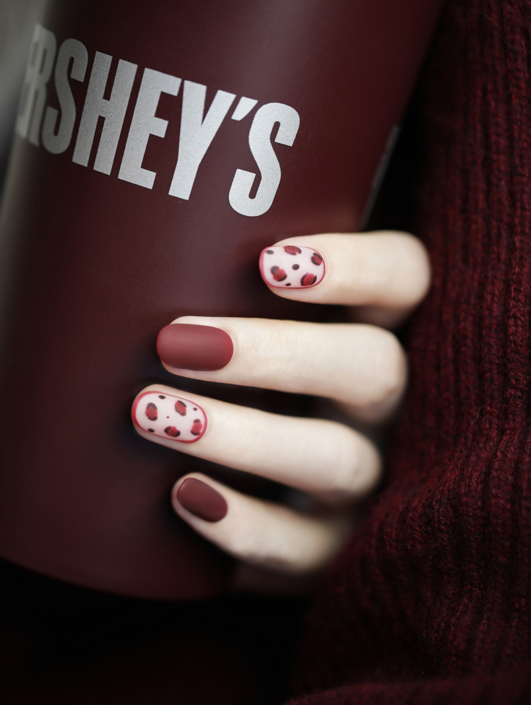 Burgundy Polka Dot Oval Nails shown as a nail art design with burgundy, simple, polka dot, oval and medium details.
