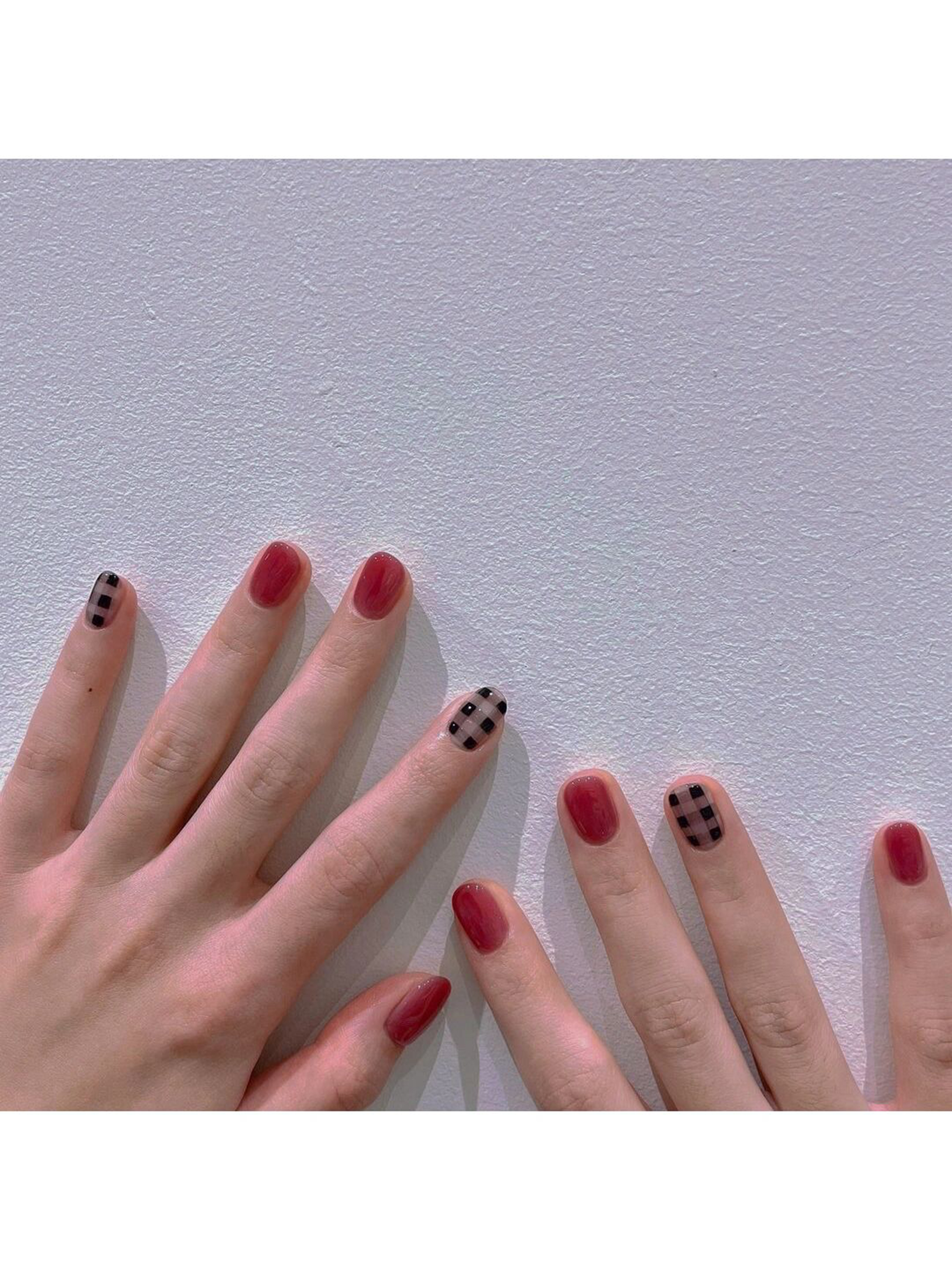 Red and Black Checkerboard Short Round Nails shown as a nail art design with red, black, minimal, easy, checkerboard, round and short details.