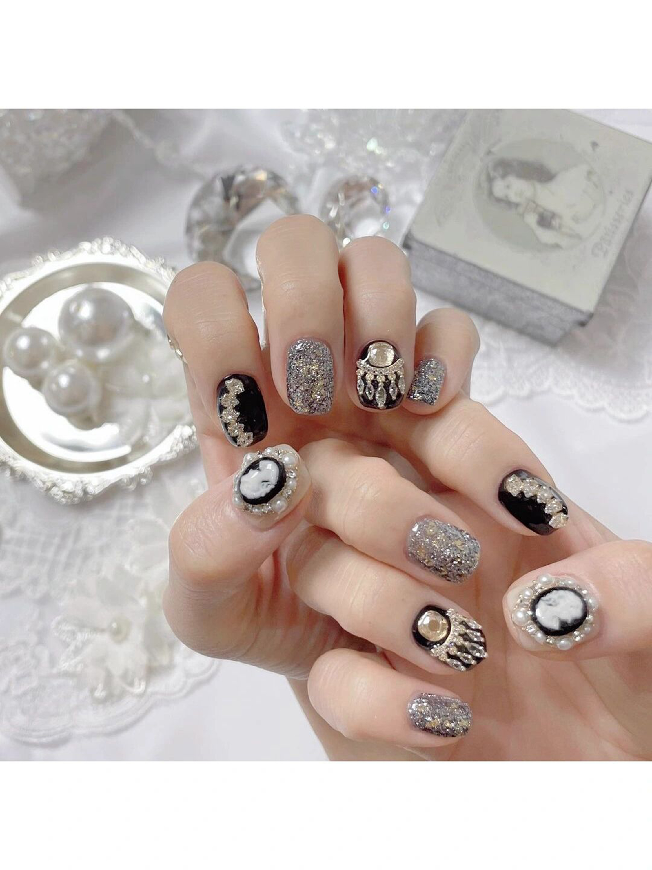 Black and White Polka Dot Short Round Nails shown as a nail art design with black, white, japanese, aesthetic, polka dot, round and short details.
