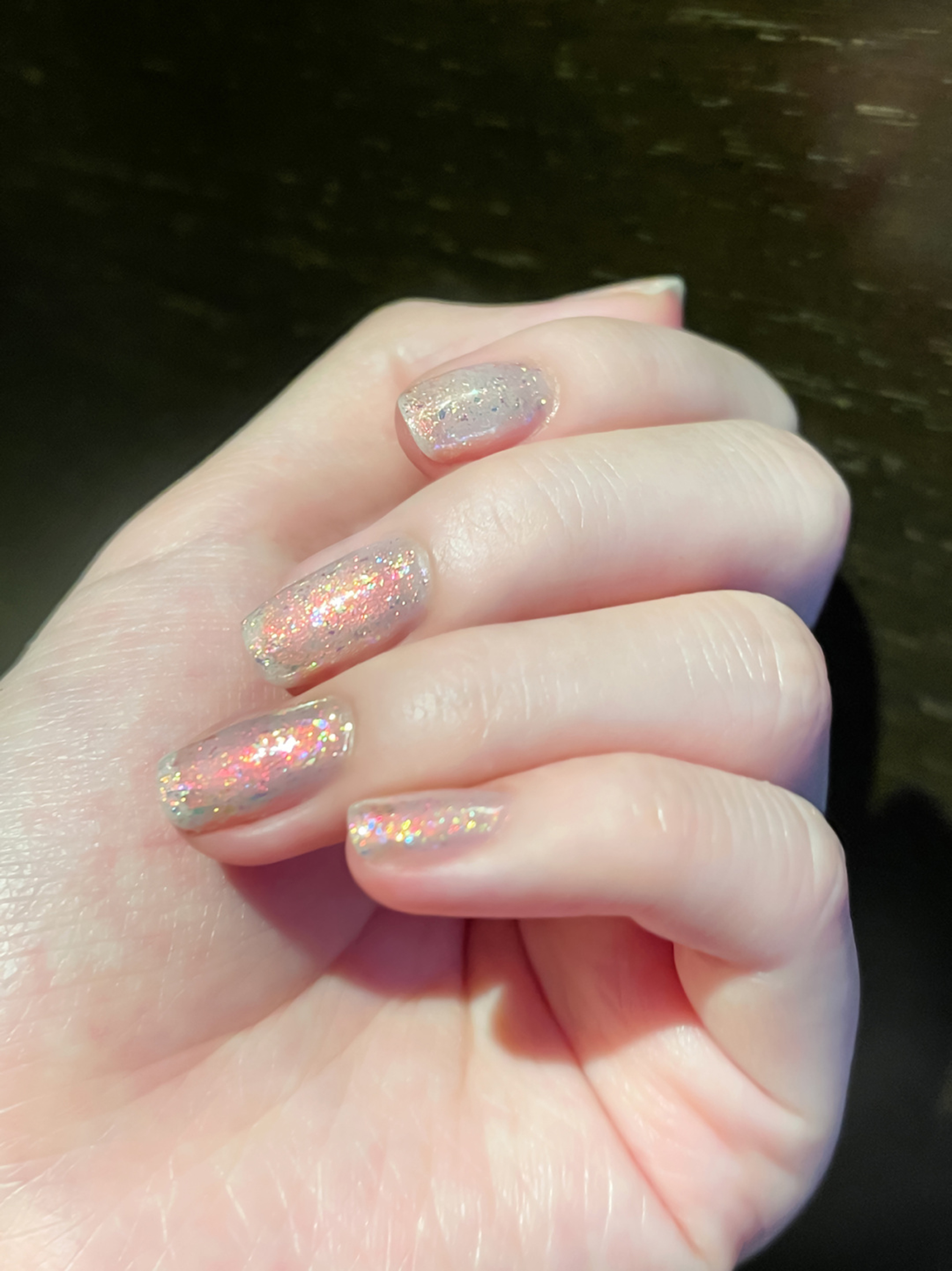 Iridescent nude glitter short nails with a sparkly finish.