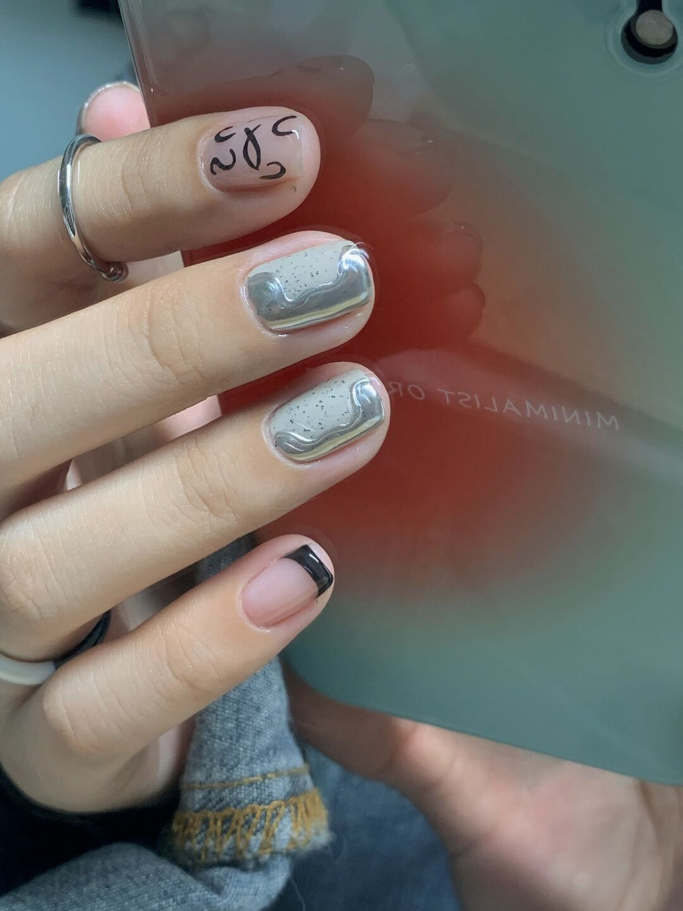 Nude and Black Abstract Short Nails shown as a nail art design with nude, black, minimal, abstract and short details.