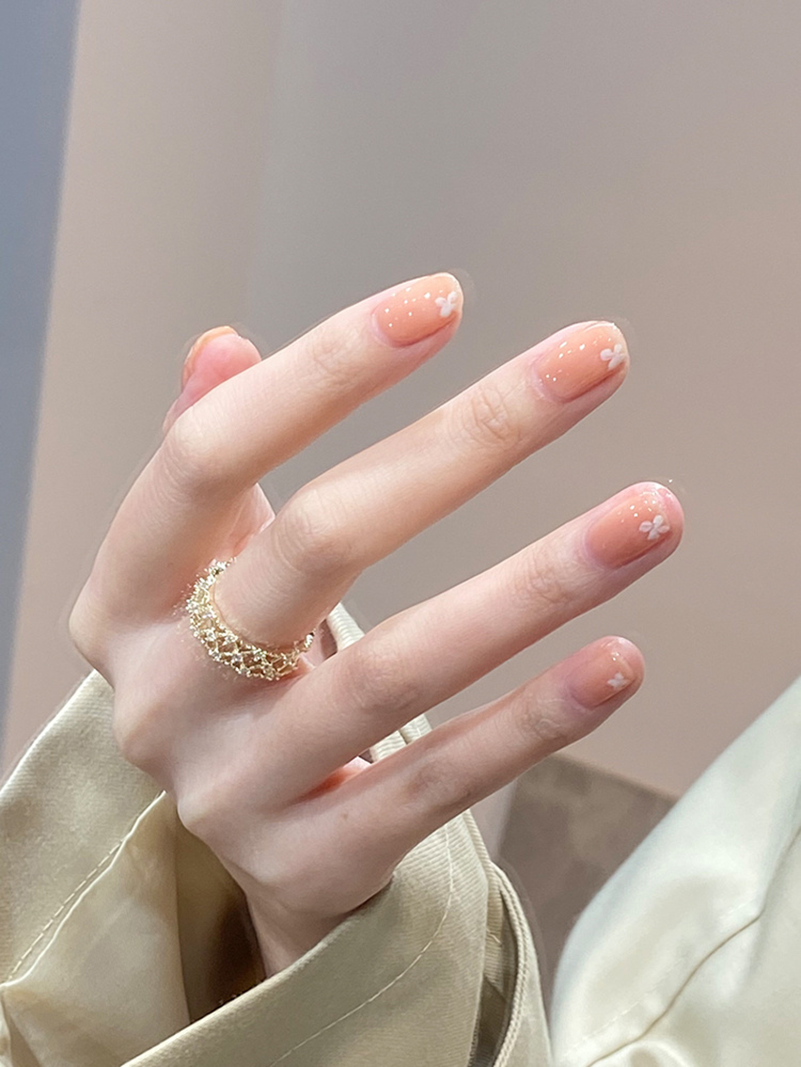 Nude and White Floral Nails shown as a nail art design with nude, white, flower and medium details.