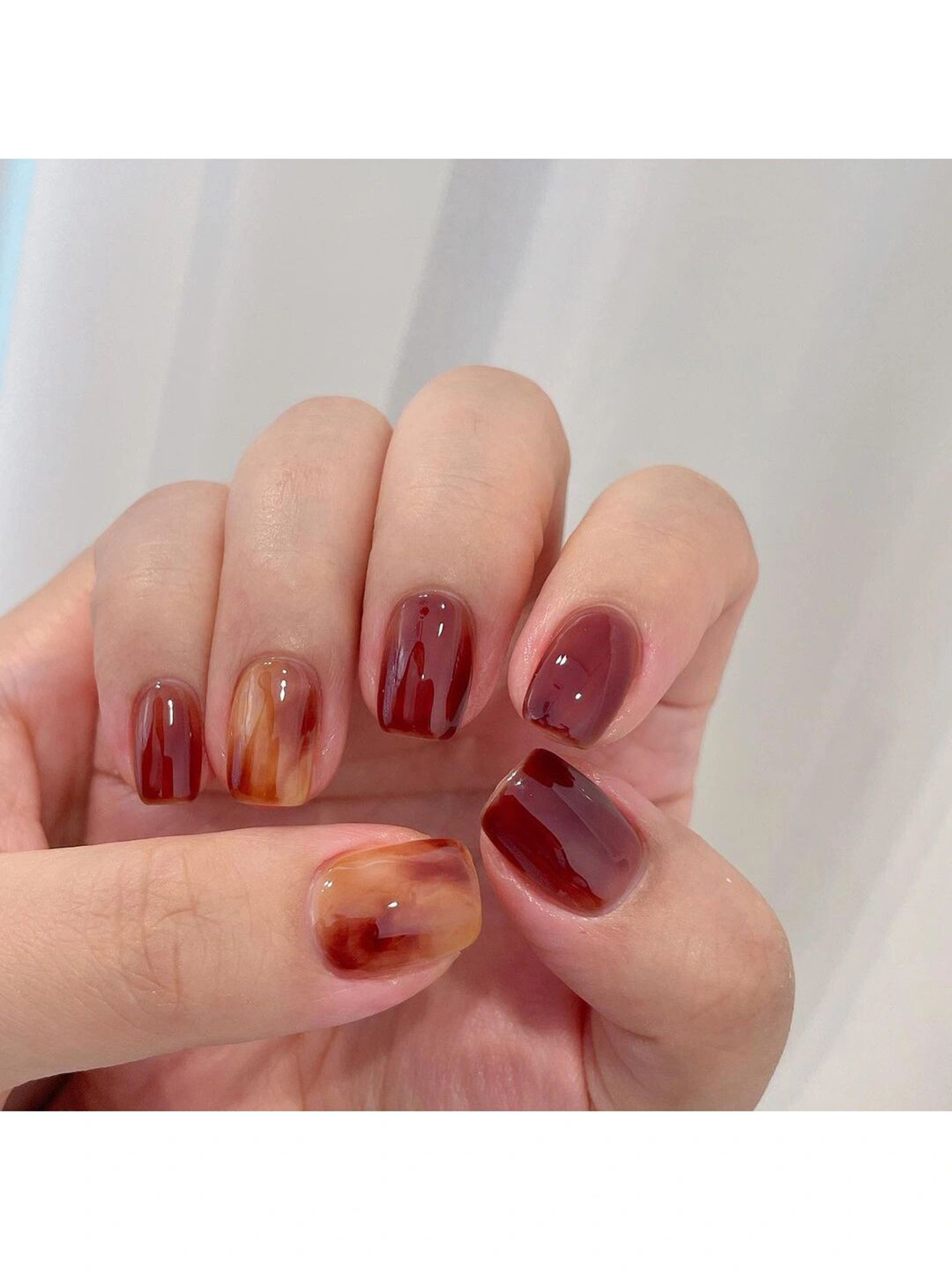 Red Marble Short Round Nails shown as a nail art design with red, marble, elegant, round and short details.