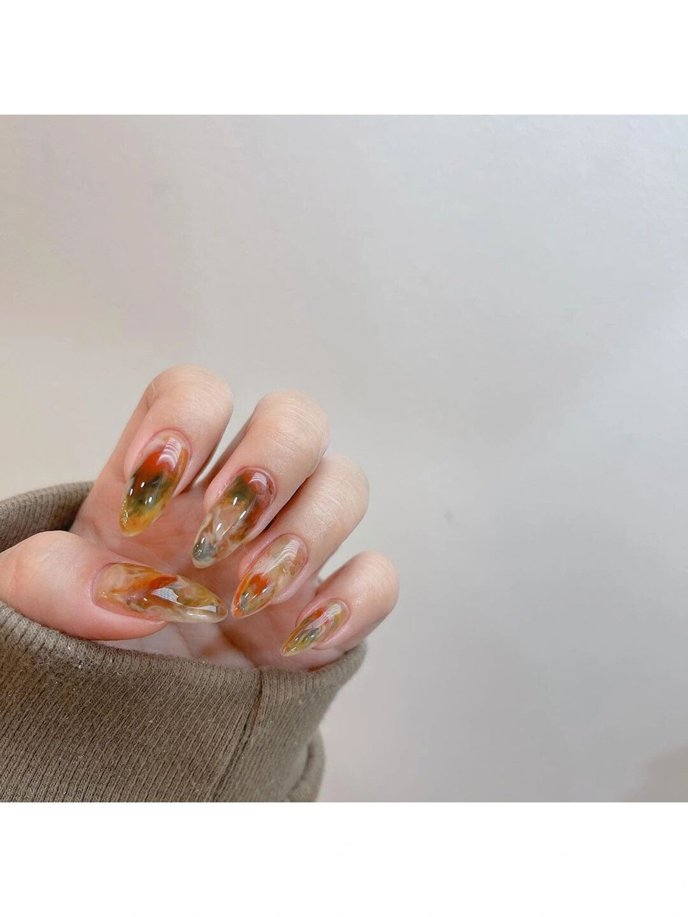 Brown and Green Marble Short Round Nails shown as a nail art design with brown, green, marble, abstract, round and short details.