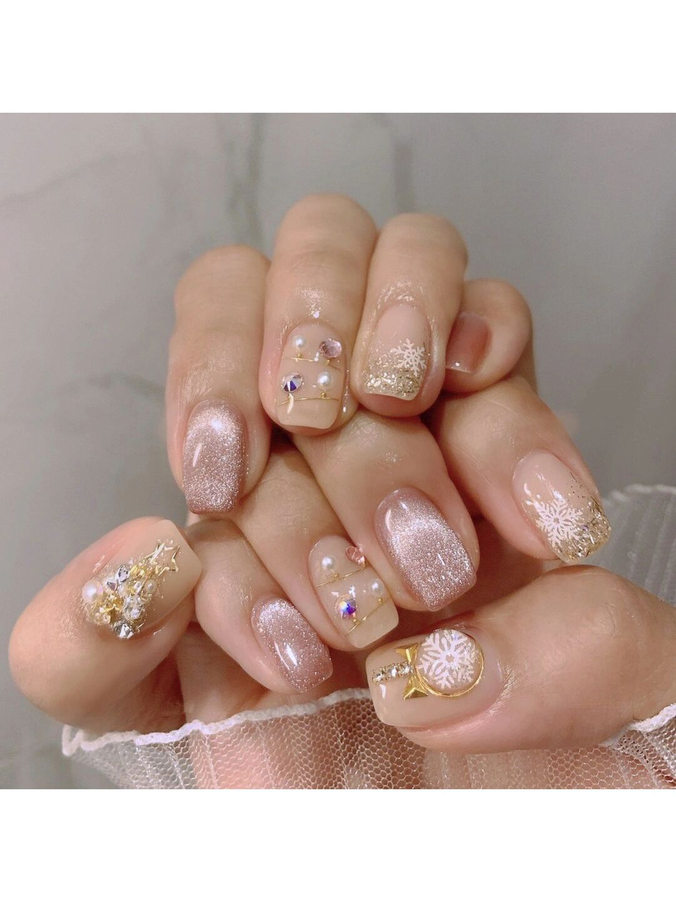 Nude and Gold Floral Short Oval Nails shown as a nail art design with nude, gold, elegant, glitter, floral, flower, oval and short details.
