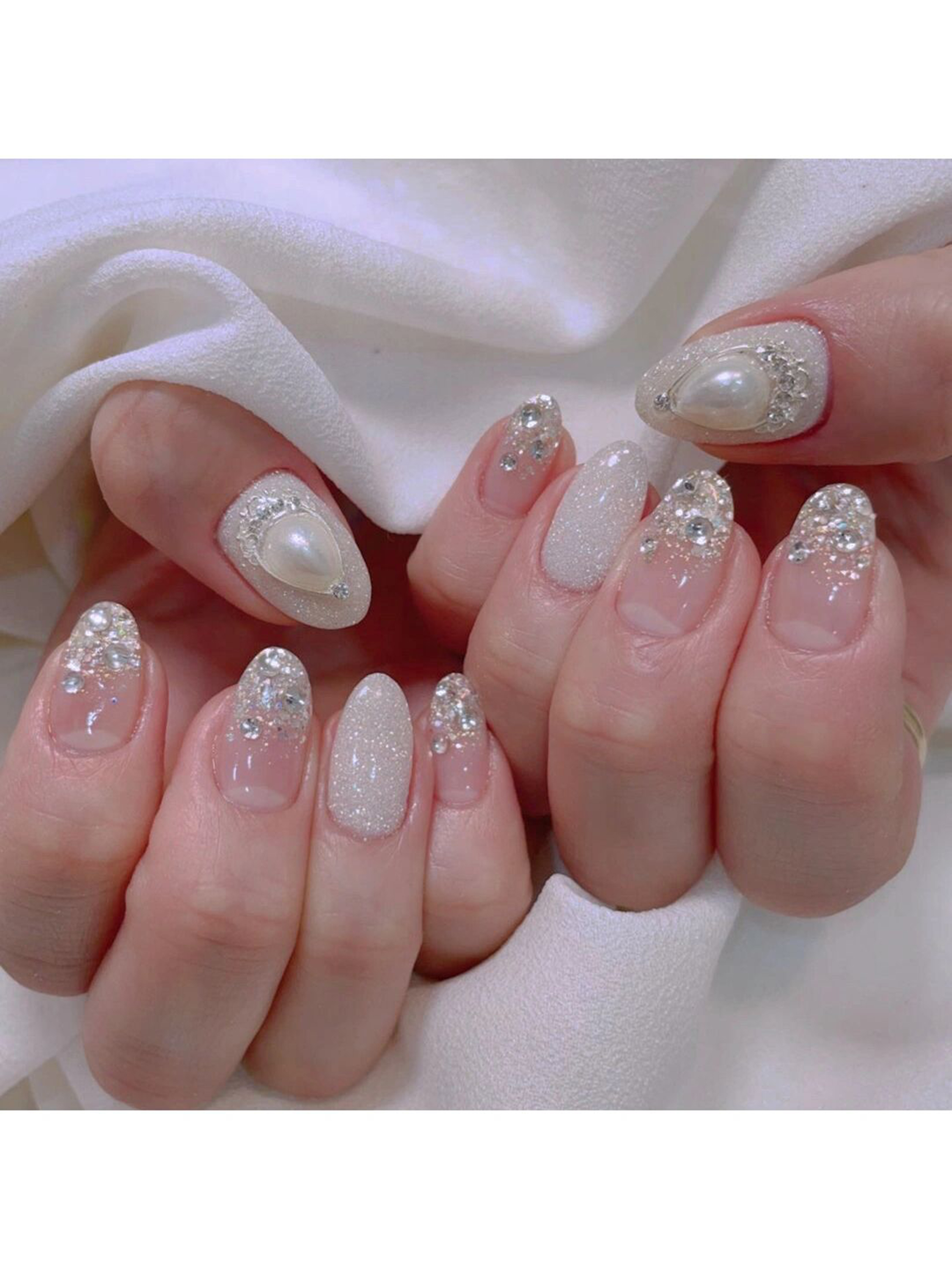 Nude and White 3D Short Oval Nails shown as a nail art design with nude, white, elegant, 3d, oval and short details.
