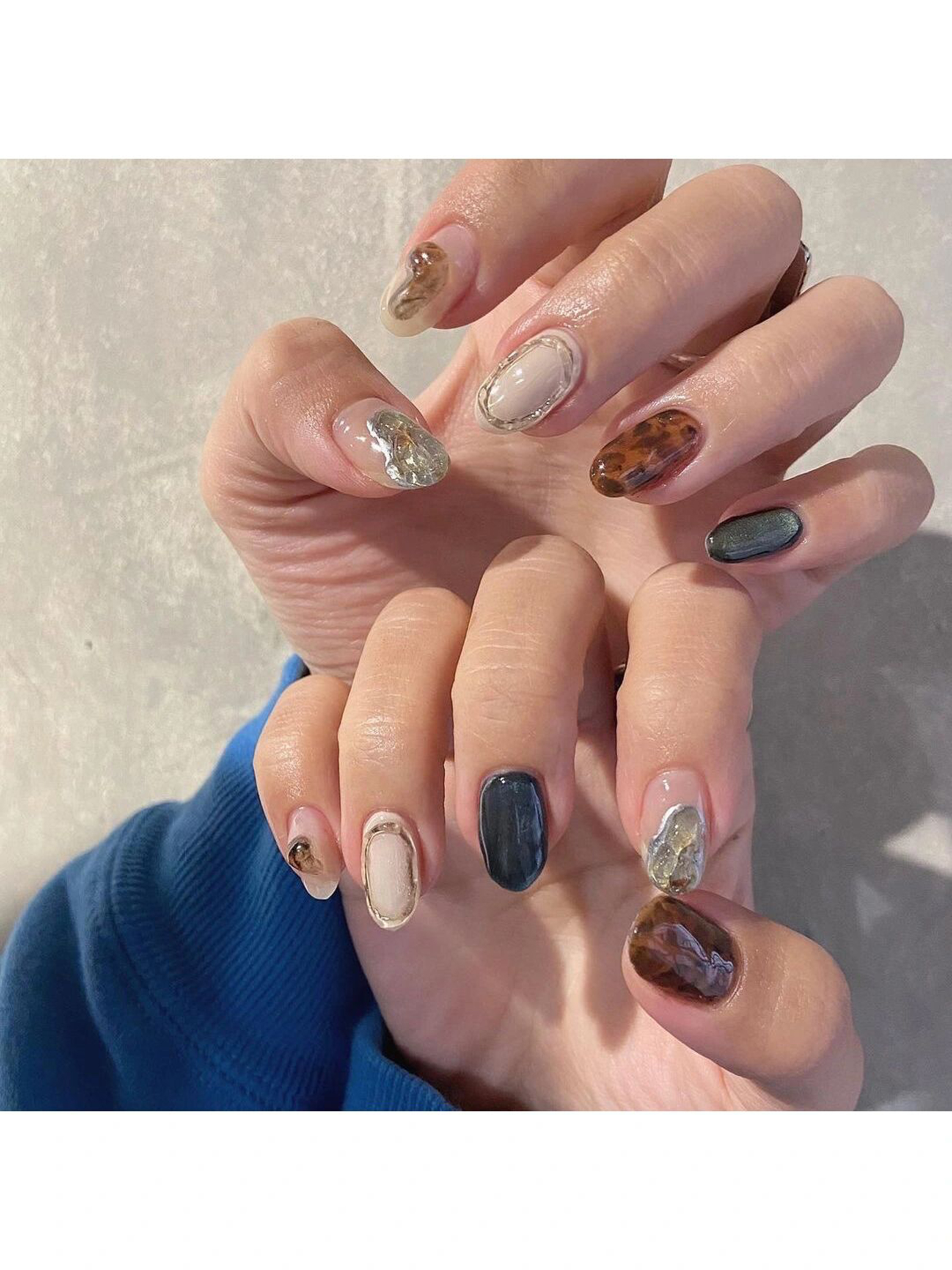 Brown and Nude Marble Oval Nails shown as a nail art design with brown, nude, marble, oval and medium details.
