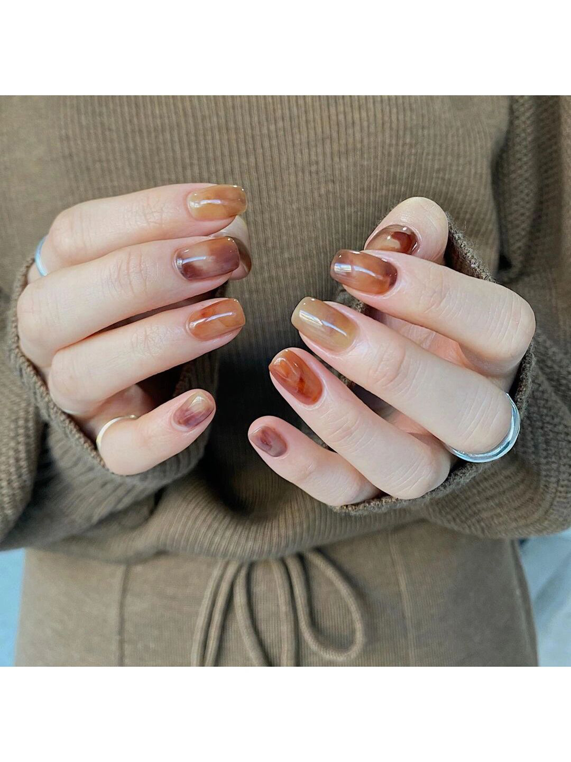 Brown Abstract Nails shown as a nail art design with brown, marble, swirl and medium details.
