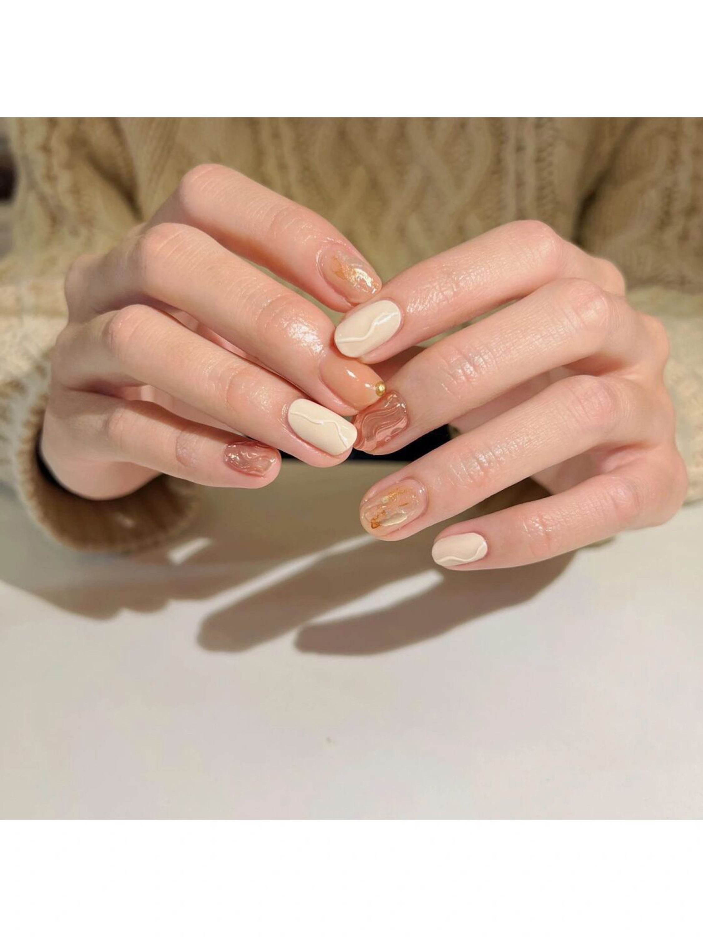 Brown, Beige and Gold Abstract Oval Nails shown as a nail art design with brown, beige, gold, marble, elegant, swirl, wave, oval and medium details.