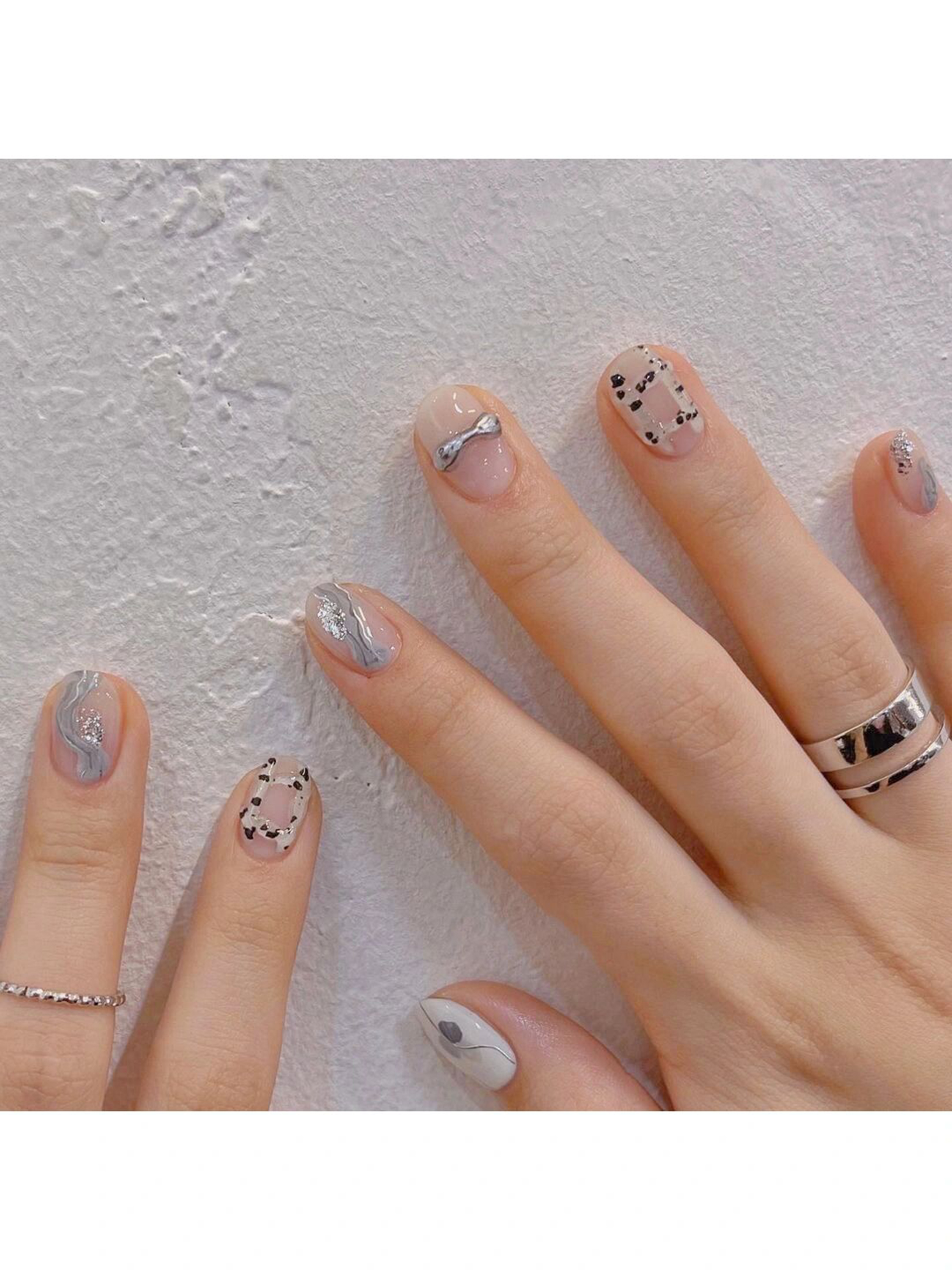 Black, Silver and Nude Bow Nails shown as a nail art design with black, silver, nude, abstract, bow and medium details.