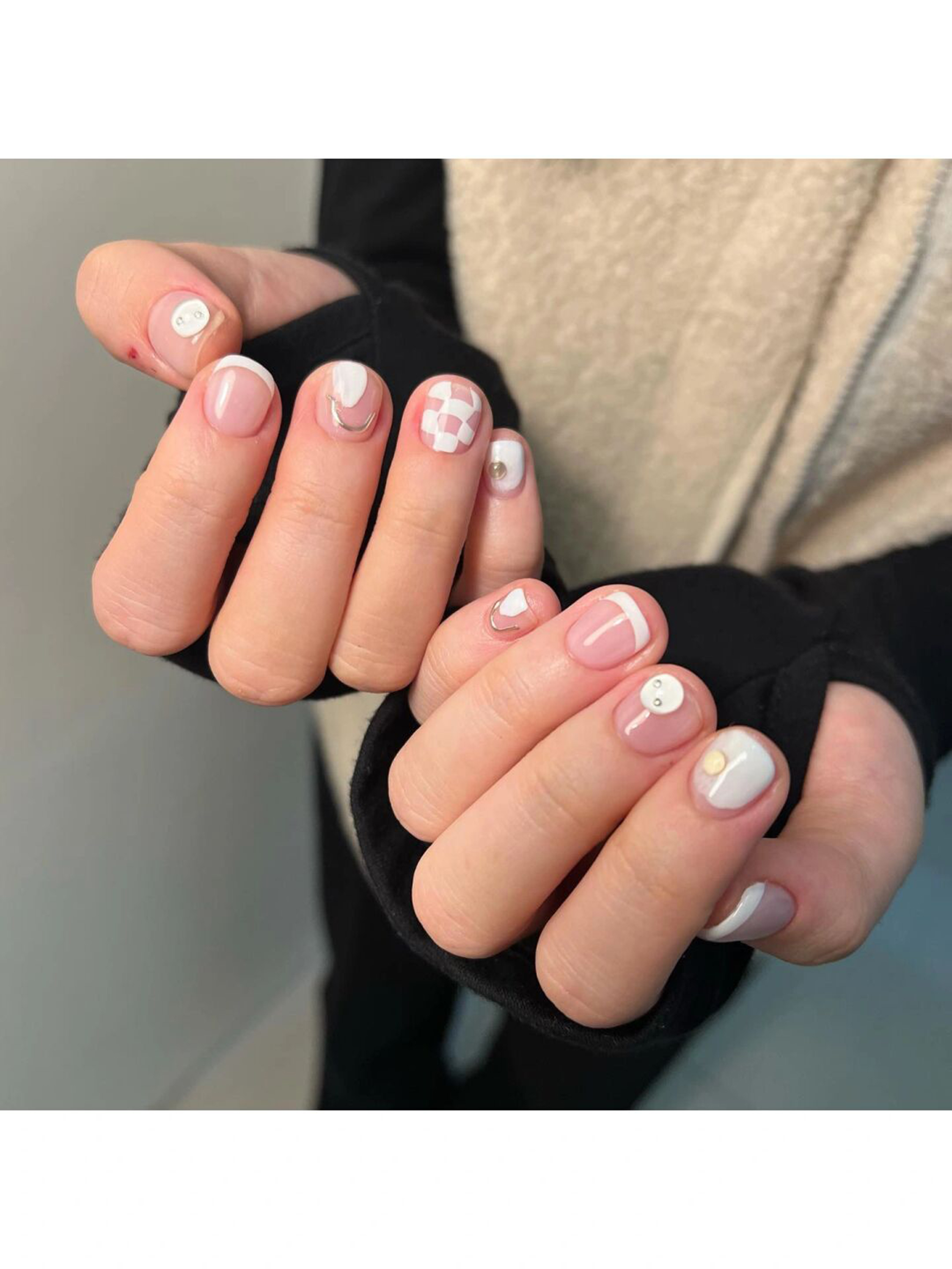 White and Nude Checkerboard Short Round Nails shown as a nail art design with white, nude, minimal, cute, checkerboard, heart, swirl, round and short details.