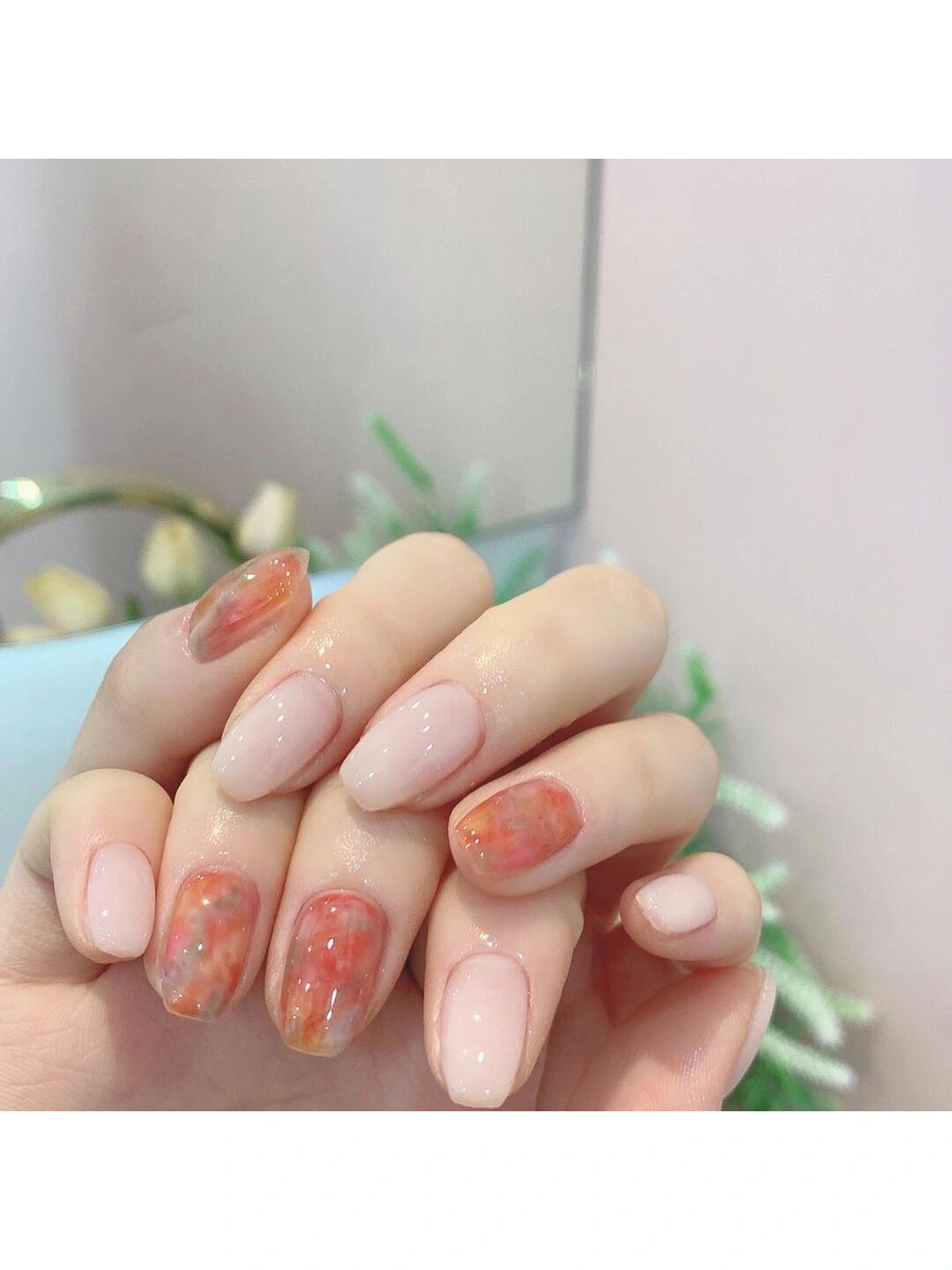 Nude and Red Marble Oval Nails shown as a nail art design with nude, red, marble, oval and medium details.