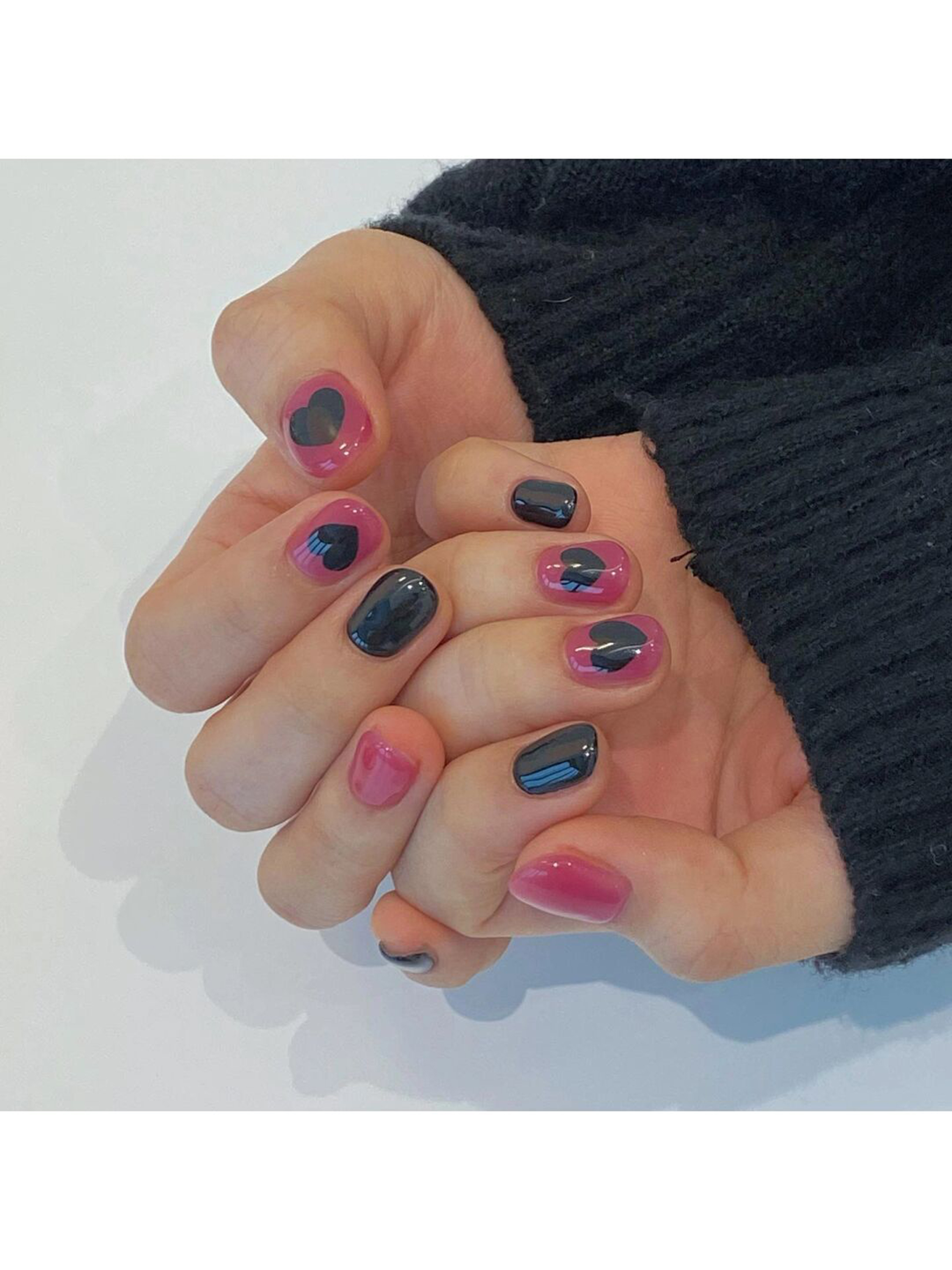 Pink and Black Heart Short Round Nails shown as a nail art design with pink, black, cute, simple, heart, round and short details.