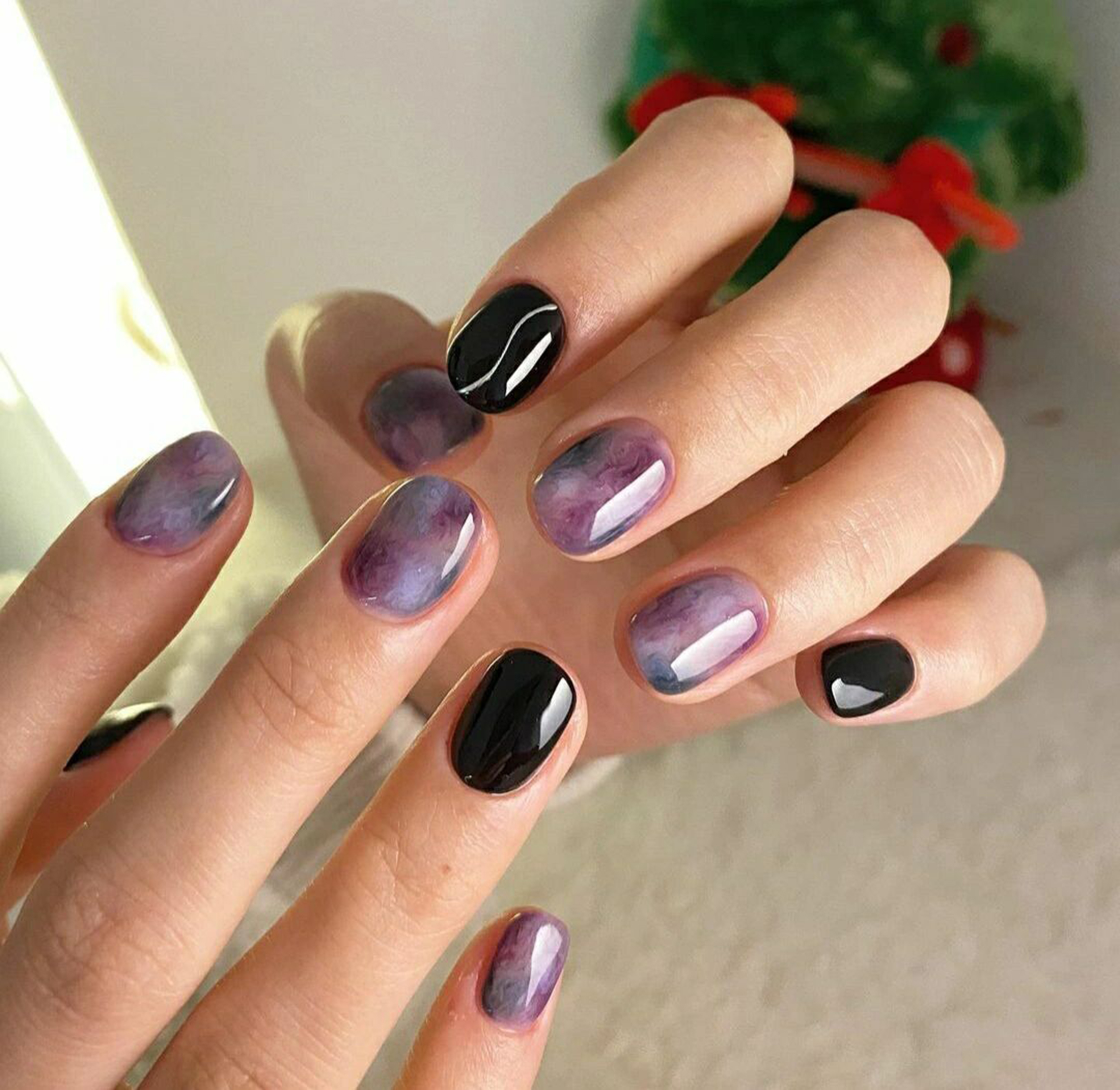 Purple and Black Abstract Short Oval Nails shown as a nail art design with purple, black, marble, swirl, wave, oval and short details.