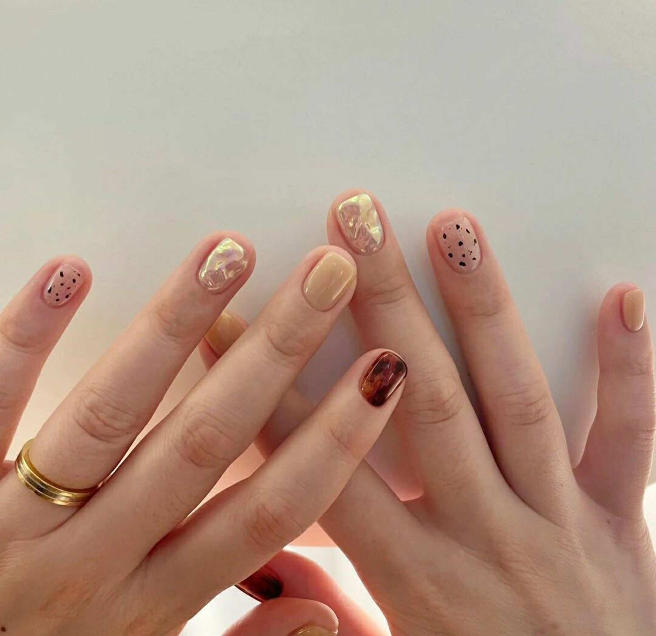 Brown and Nude Polka Dot Short Round Nails shown as a nail art design with brown, nude, marble, polka dot, round and short details.