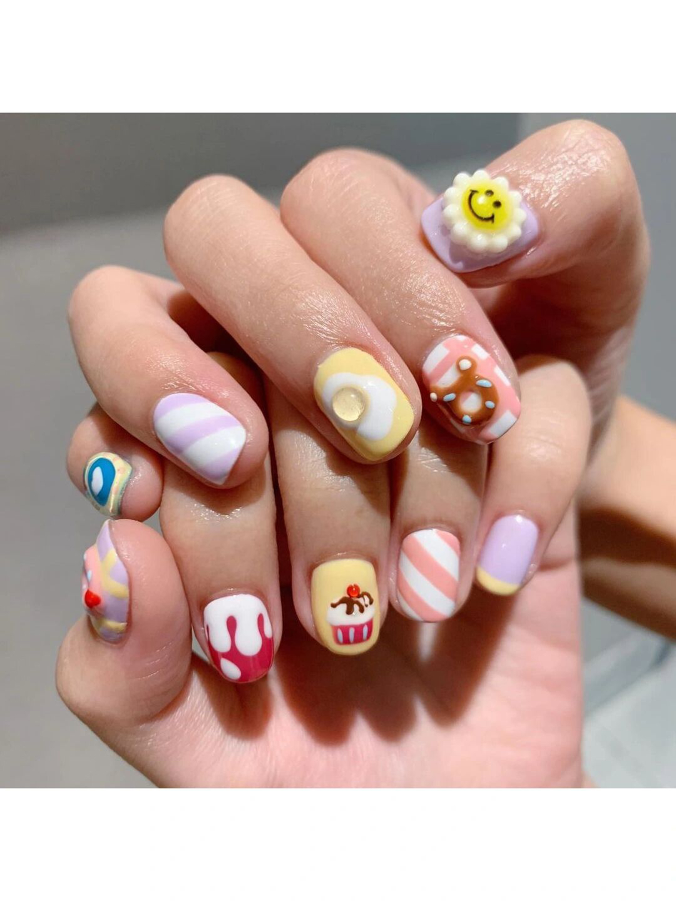 Pink, White and Butter Yellow Abstract Short Round Nails shown as a nail art design with pink, white, butter yellow, cute, 3d, swirl, round and short details.
