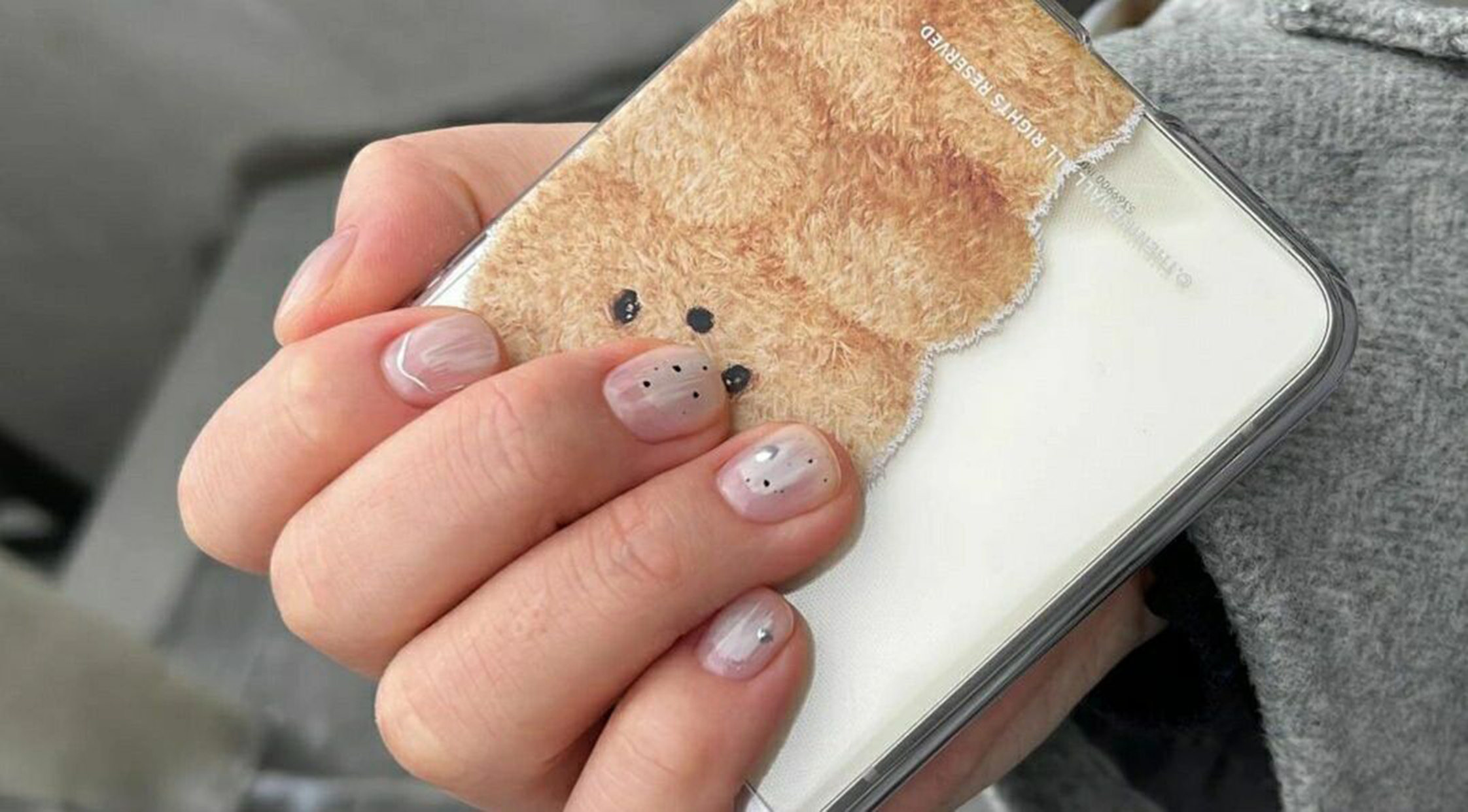 Nude and Black Polka Dot Short Round Nails shown as a nail art design with nude, black, polka dot, round and short details.