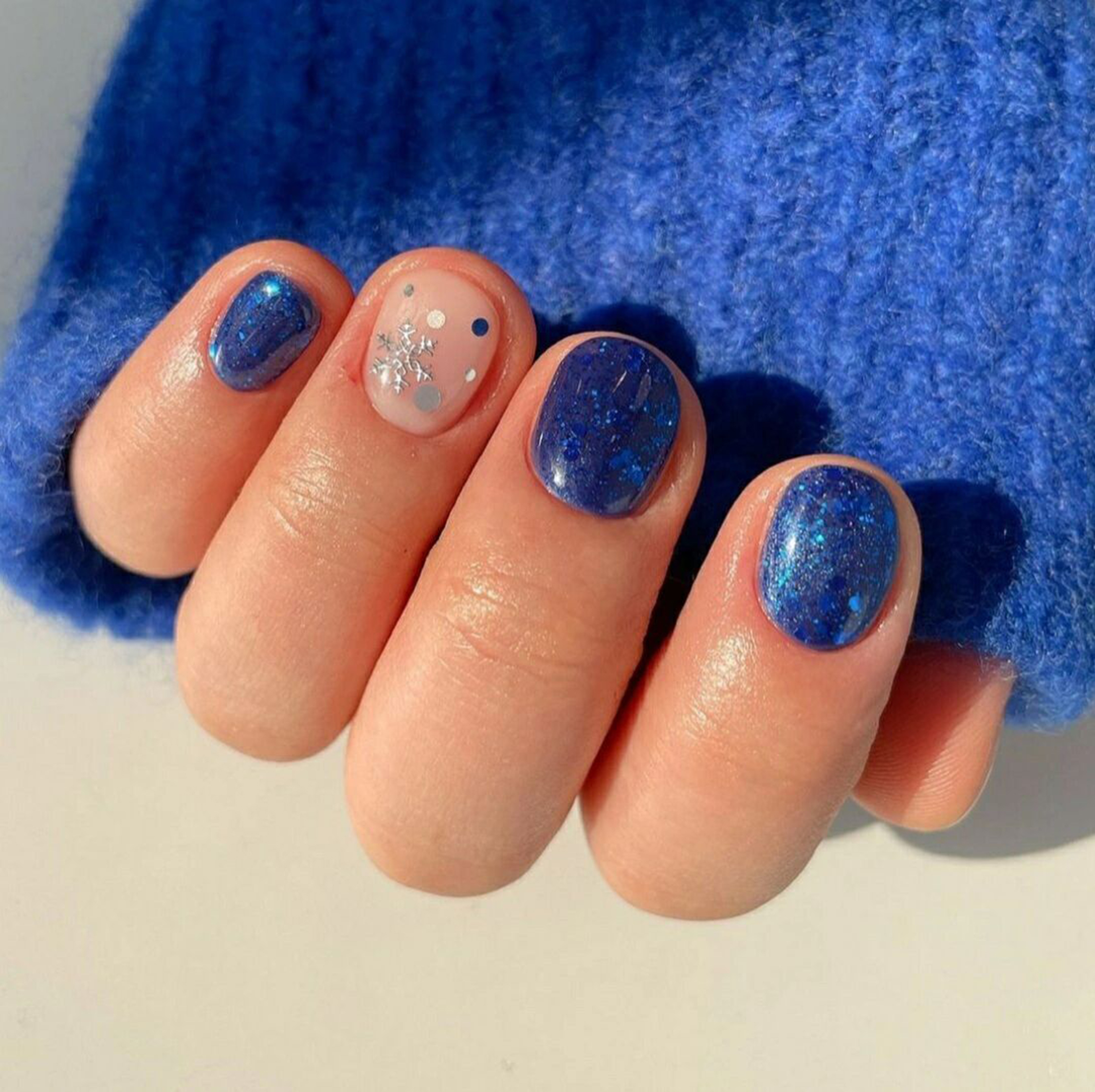 Blue and Nude Polka Dot Short Round Nails shown as a nail art design with blue, nude, glitter, cute, polka dot, round and short details.