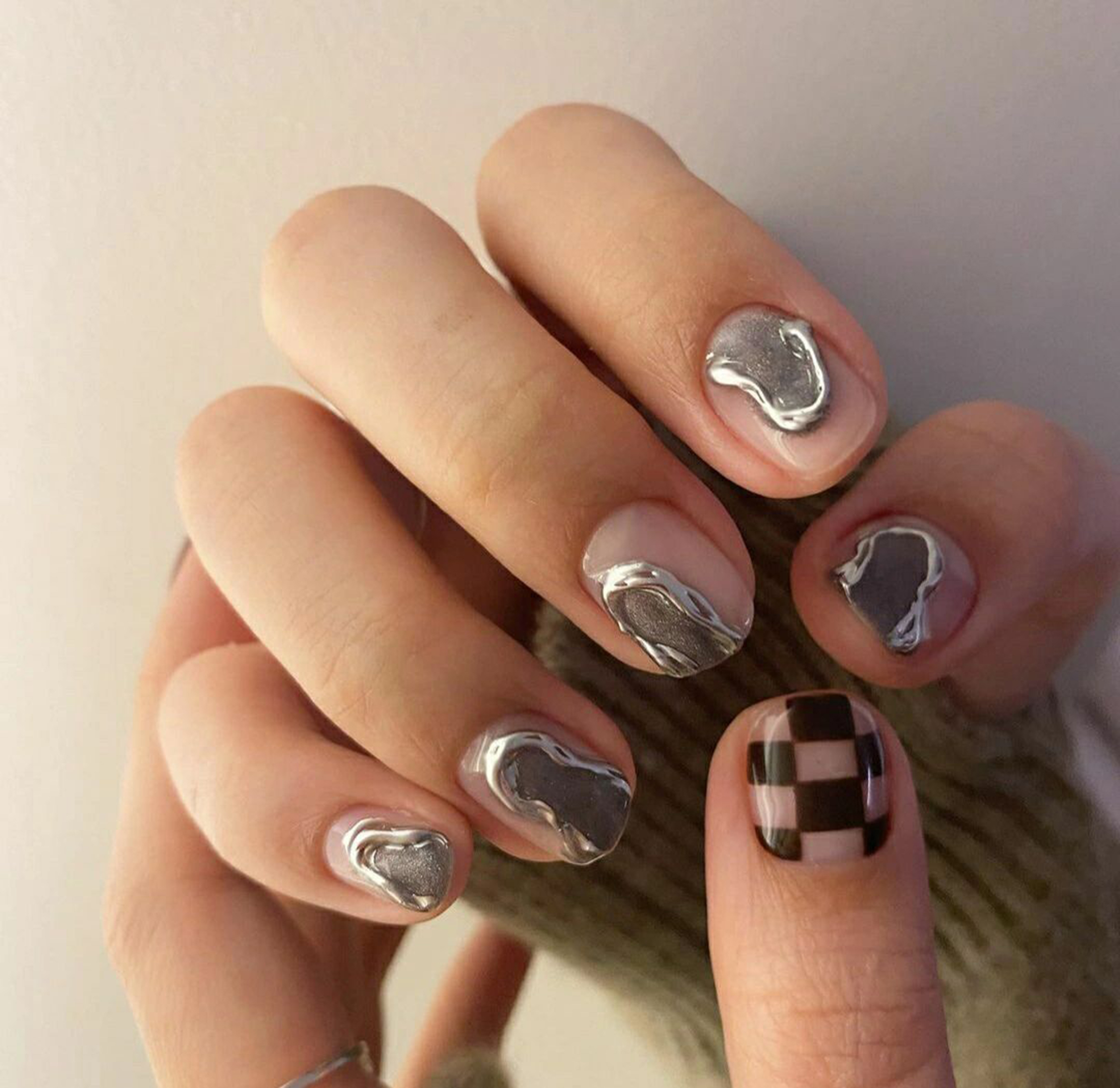 Black and Silver Checkerboard Short Round Nails shown as a nail art design with black, silver, chrome, checkerboard, round and short details.