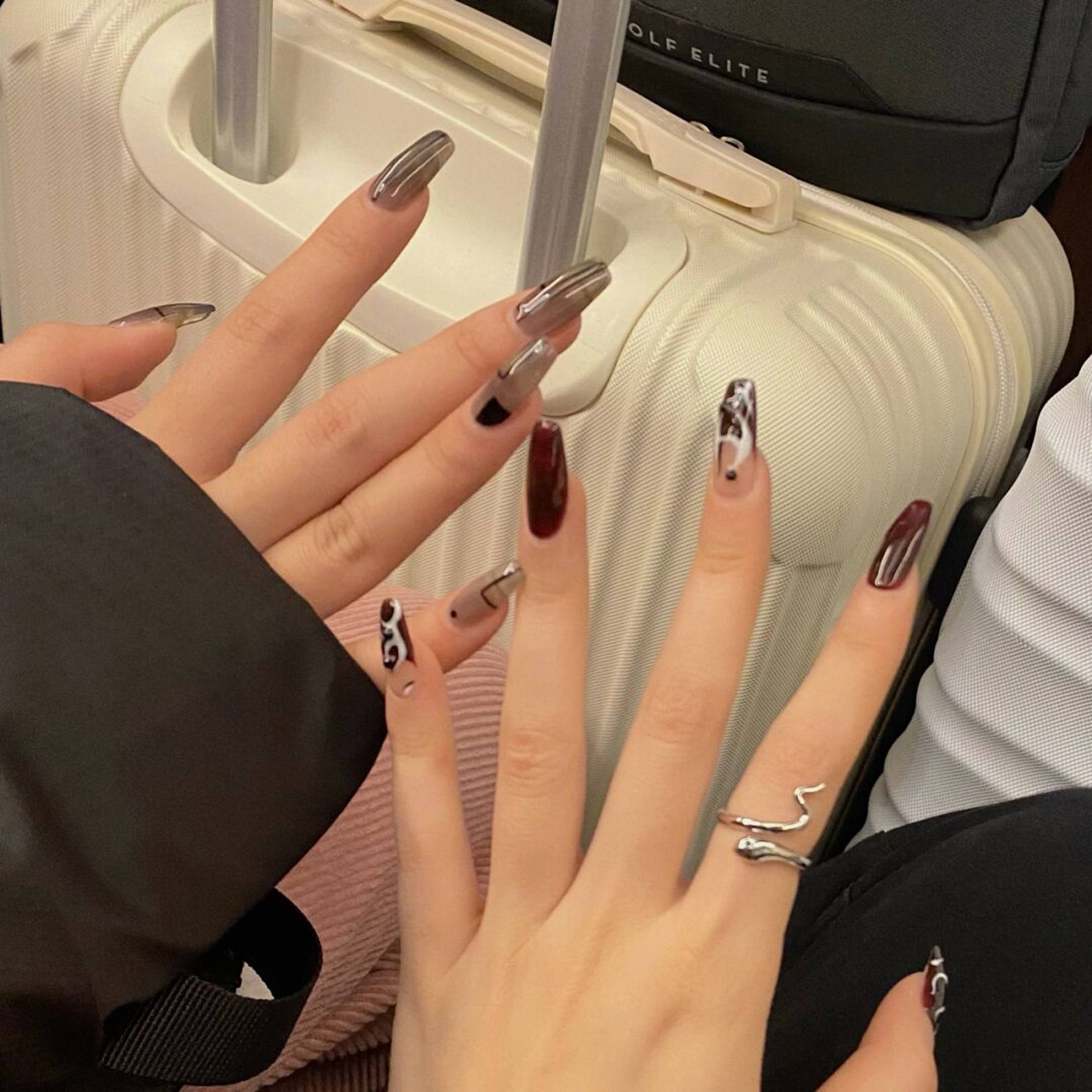 Silver, Burgundy and Black Chrome Long Coffin Nails shown as a nail art design with silver, burgundy, black, chrome, animal print, coffin and long details.