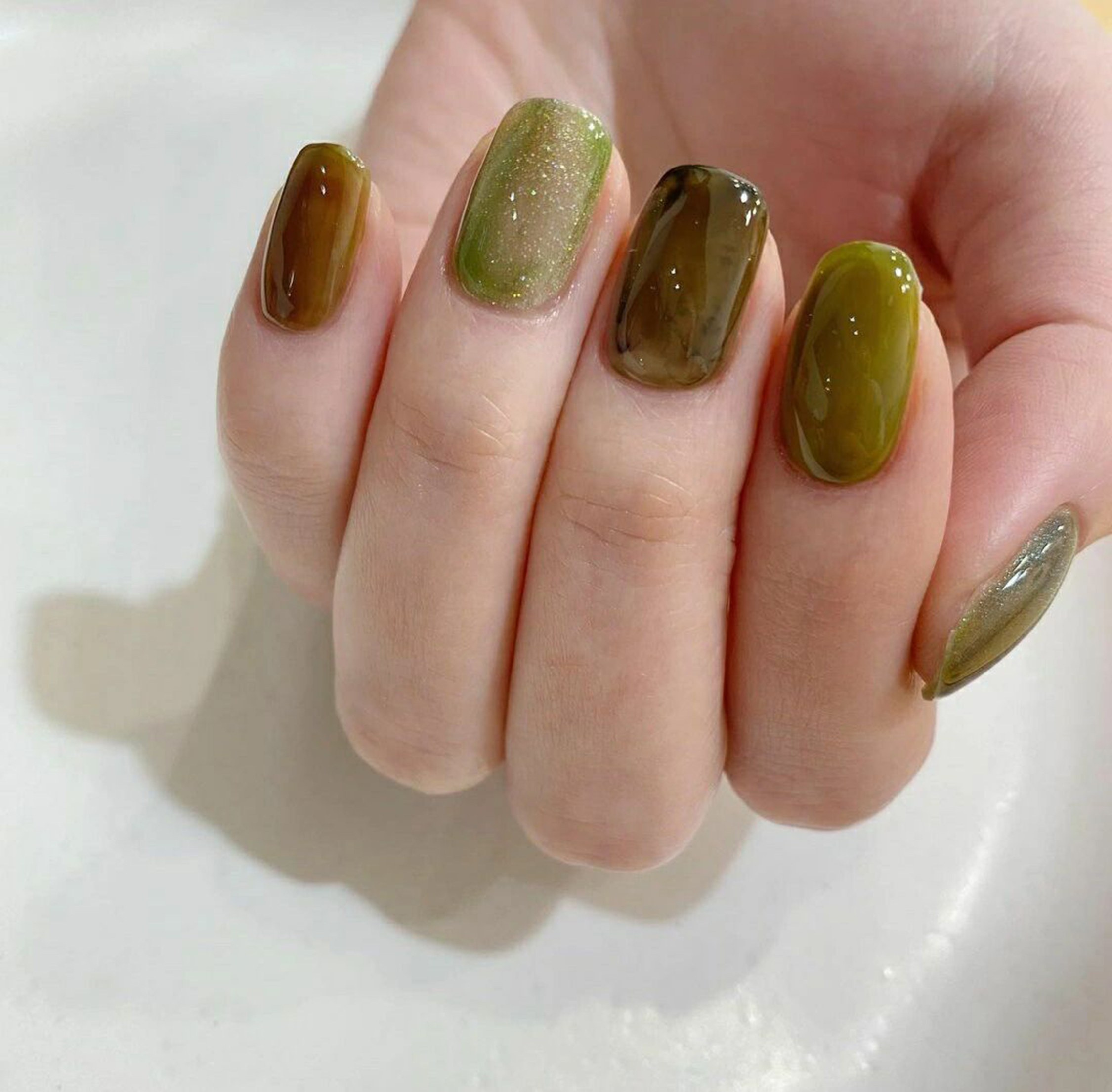 Green and Brown Marble Nails shown as a nail art design with green, brown, marble and medium details.